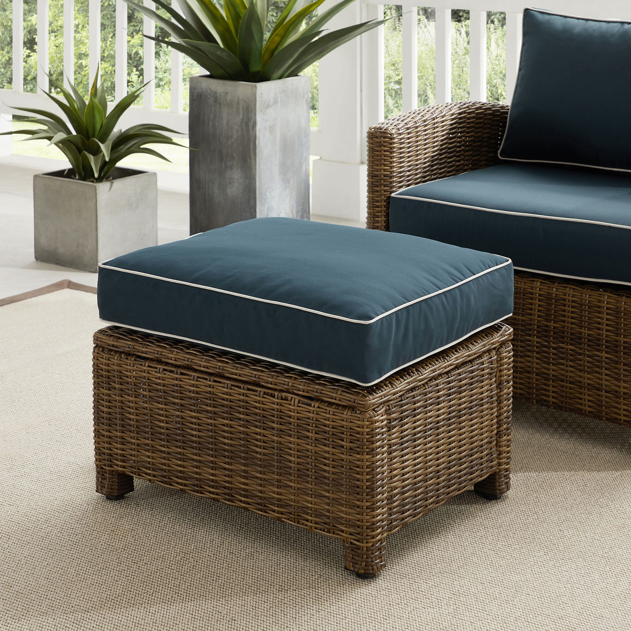 The appearance of Bradenton Wicker Outdoor Ottoman In Navy and Weathered Brown designed by Crosley Brands in the traditional interior design. This navy piece of furniture was selected by 1StopBedrooms from Bradenton Collection to add a touch of cosiness and style into your home. Sku: CO7126-WB;CO7416-NV. Material: Polyester.