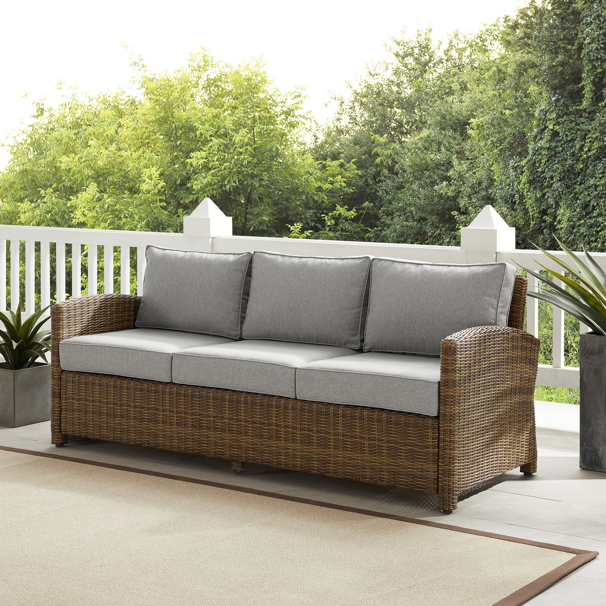 The appearance of Bradenton Wicker Outdoor Sofa In Gray and Weathered Brown designed by Crosley Brands in the traditional interior design. This gray piece of furniture was selected by 1StopBedrooms from Bradenton Collection to add a touch of cosiness and style into your home. Sku: CO7131-WB-2OF2;CO7131-WB-1OF2;MO7495-GY. Material: Polyester.