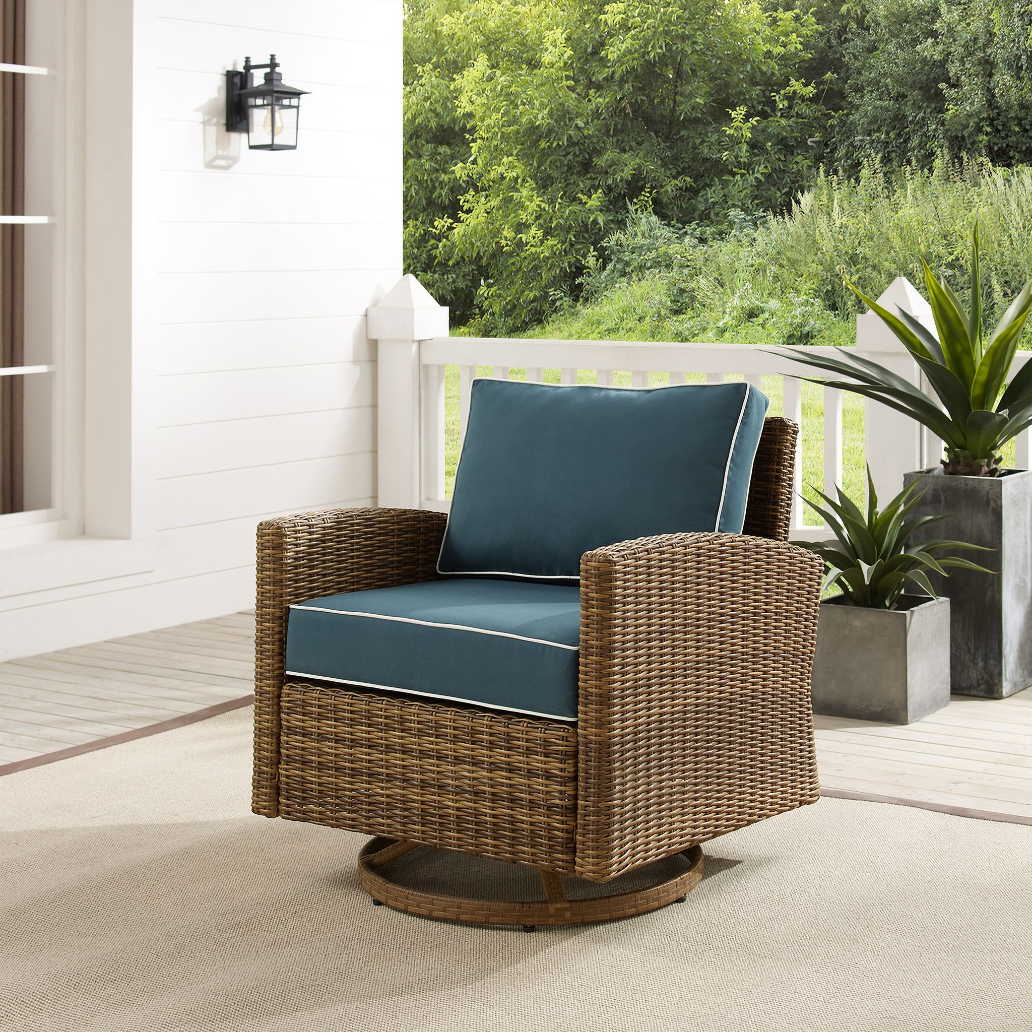 The appearance of Bradenton Wicker Swivel Rocker Outdoor Chair In Navy and Weathered Brown designed by Crosley Brands in the traditional interior design. This navy piece of furniture  was selected by 1StopBedrooms from Bradenton Collection to add a touch of cosiness and style into your home. Sku: CO7127-WB;CO7401-NV. Material: Polyester.