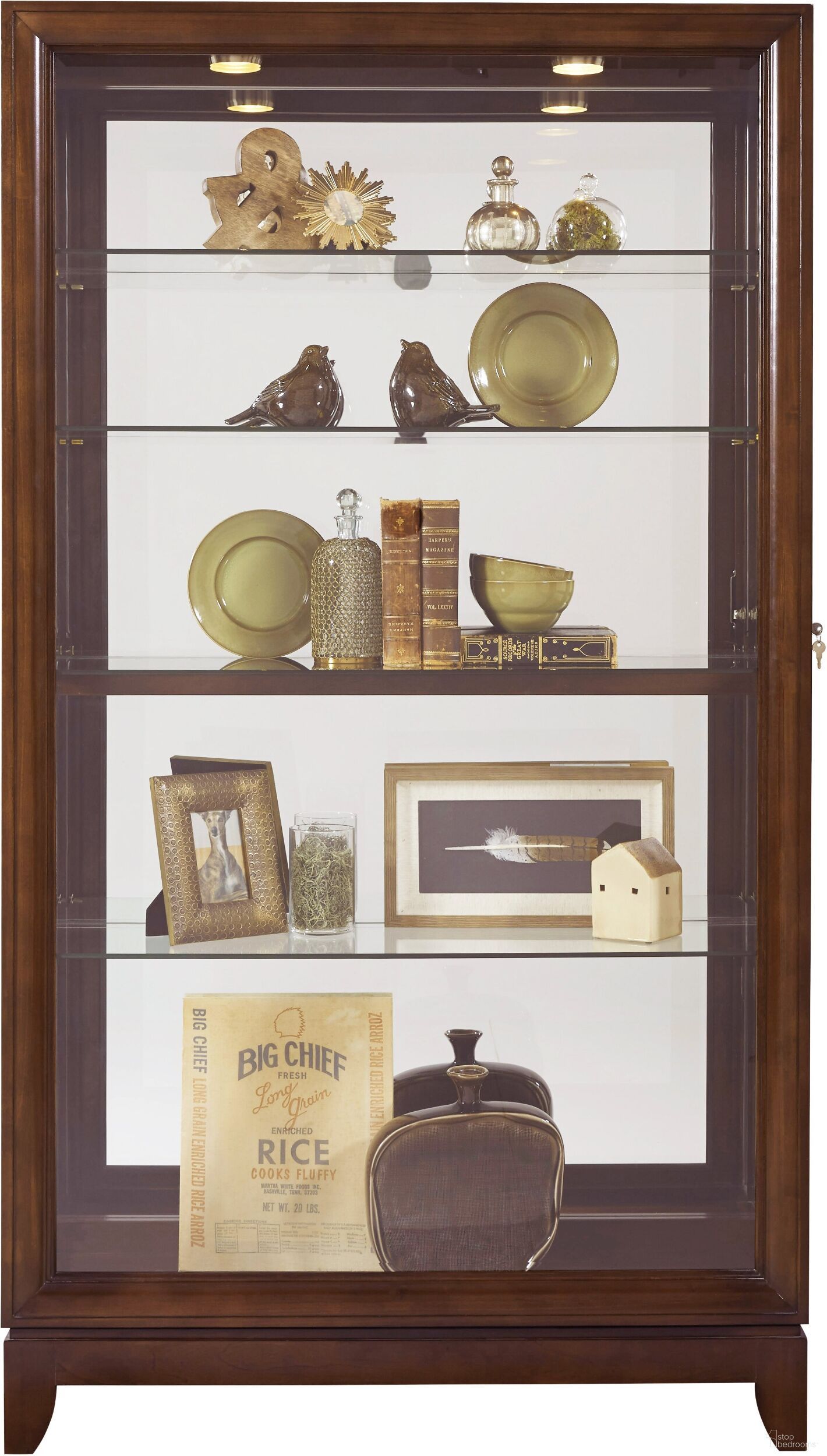 The appearance of Chocolate Cherry Door Curio designed by Pulaski in the transitional interior design. This brown piece of furniture was selected by 1StopBedrooms from Curios Collection to add a touch of cosiness and style into your home. Sku: 20661. Material: Glass.