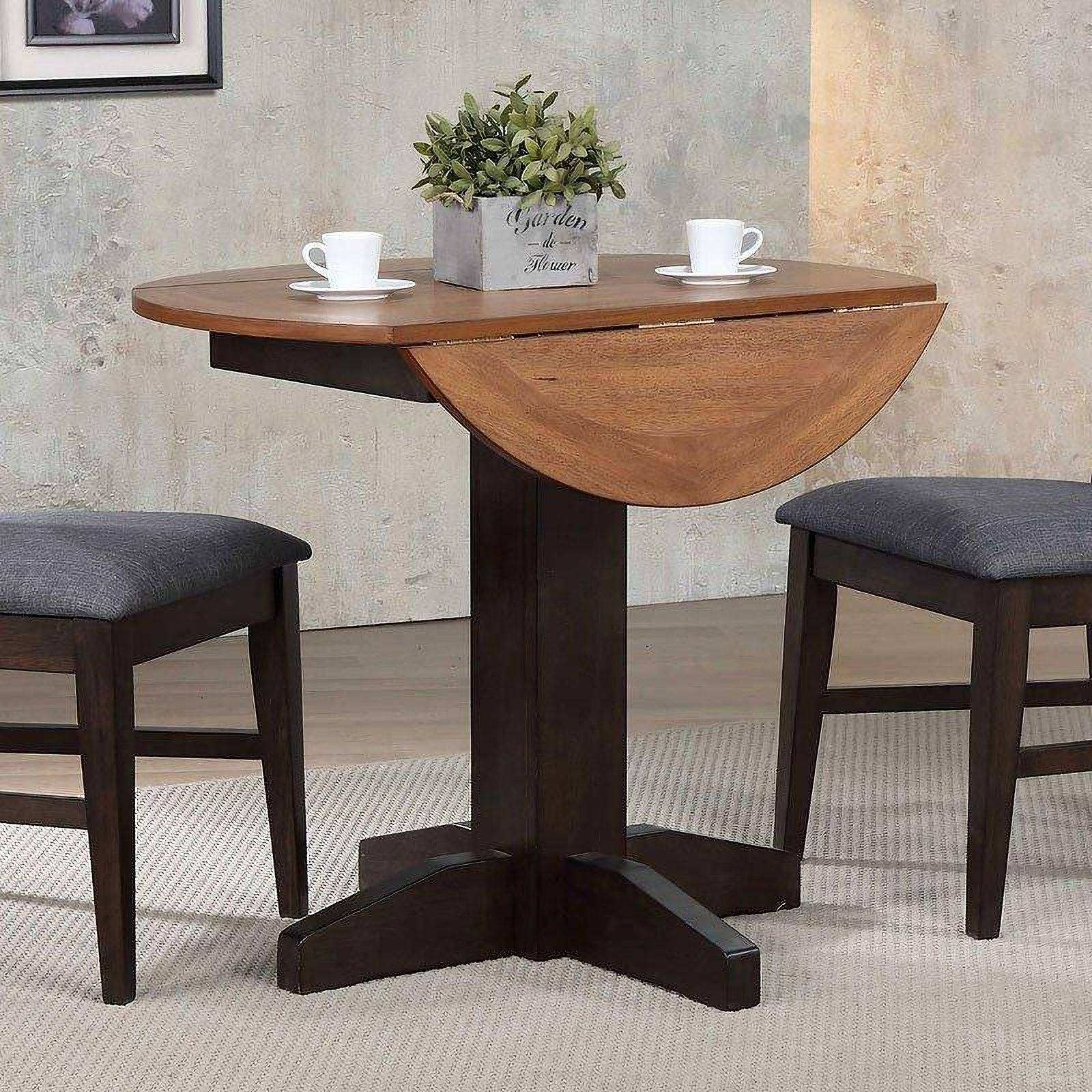 The appearance of Choices Black Oak 20 Inch Extendable Dining Table designed by ECI in the transitional interior design. This black piece of furniture  was selected by 1StopBedrooms from Choices Collection to add a touch of cosiness and style into your home. Sku: 0733-50-DLT;0733-50-DLB. Table Base Style: Pedestal. Table Top Shape: Round. Size: 20". Material: Hardwood.