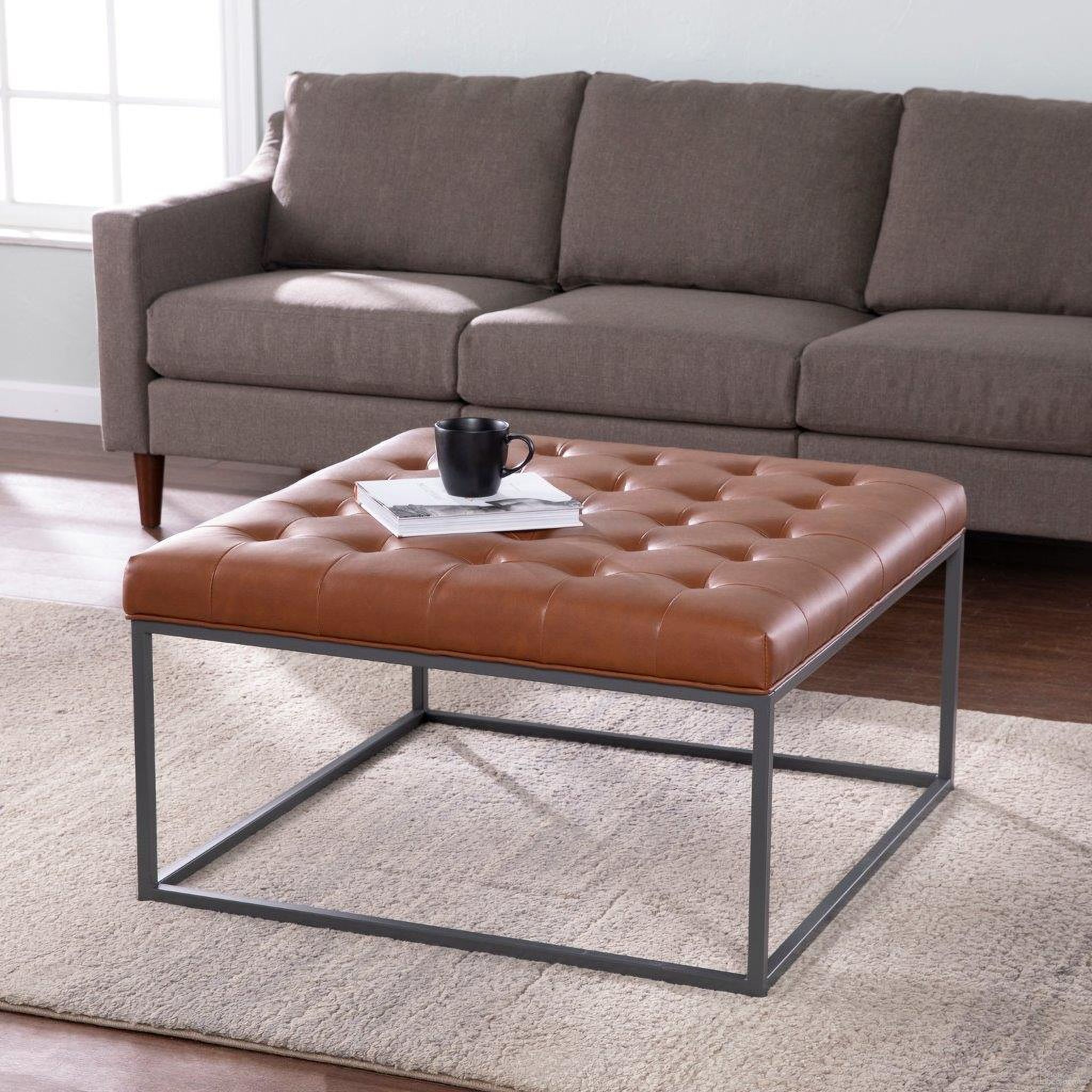 The appearance of Ciarin Upholstered Cocktail Ottoman In Brown designed by SEI Furniture in the modern / contemporary interior design. This brown piece of furniture was selected by 1StopBedrooms from Ciarin Collection to add a touch of cosiness and style into your home. Sku: BC1101926. Material: Faux Leather.