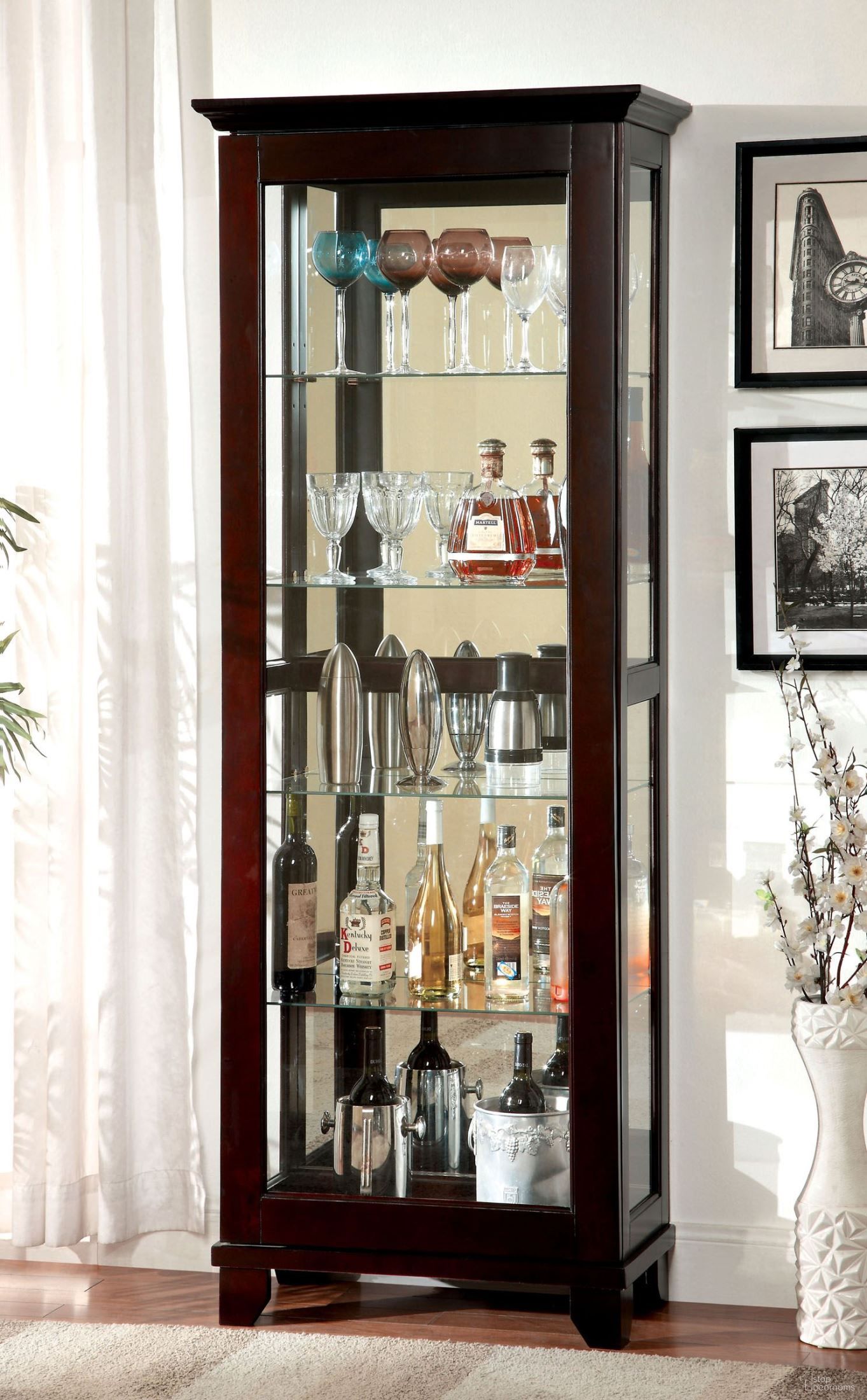 The appearance of Ludden Dark Walnut Curio Cabinet designed by Furniture of America in the modern / contemporary interior design. This brown piece of furniture  was selected by 1StopBedrooms from Ludden Collection to add a touch of cosiness and style into your home. Sku: CM-CR135. Material: Wood.