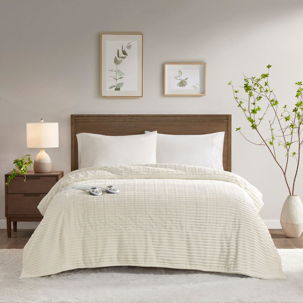 The appearance of Corded Plush Heated Queen Blanket In Ivory designed by Olliix in the transitional interior design. This ivory piece of furniture was selected by 1StopBedrooms from Corded Plush Collection to add a touch of cosiness and style into your home. Sku: ST54-0284. Material: Polyester. Bed Size: Queen.
