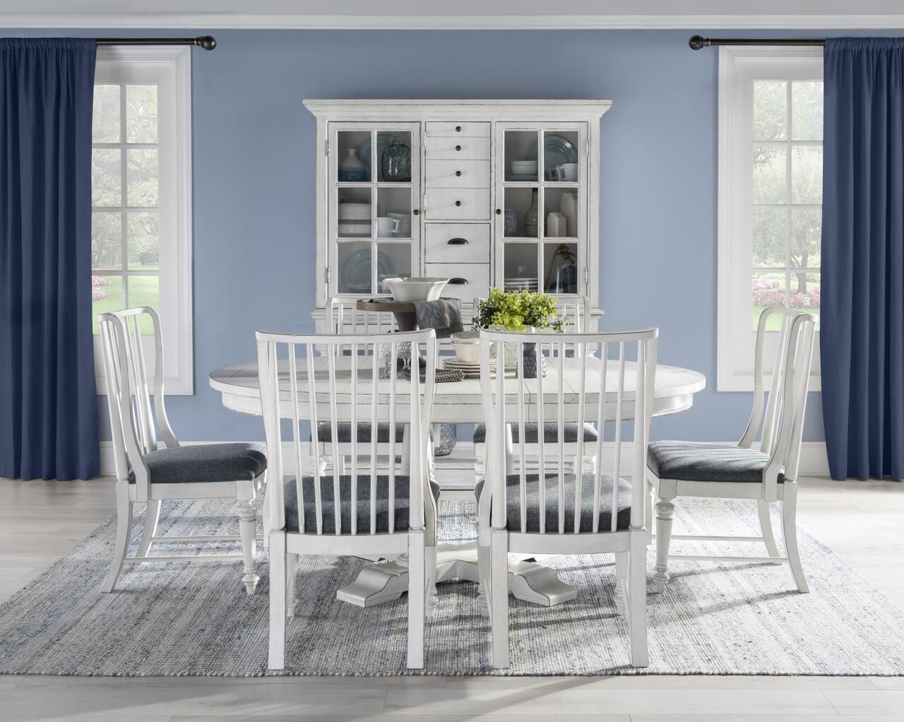 The appearance of Cottage Park Complete Round Dining Room Set In Aged White designed by Legacy Classic in the modern / contemporary interior design. This aged white piece of furniture  was selected by 1StopBedrooms from Cottage Park Collection to add a touch of cosiness and style into your home. Sku: 2430-521T;2430-521B;2430-140. Table Top Shape: Oval. Material: Hardwood. Size: 72" x 54".