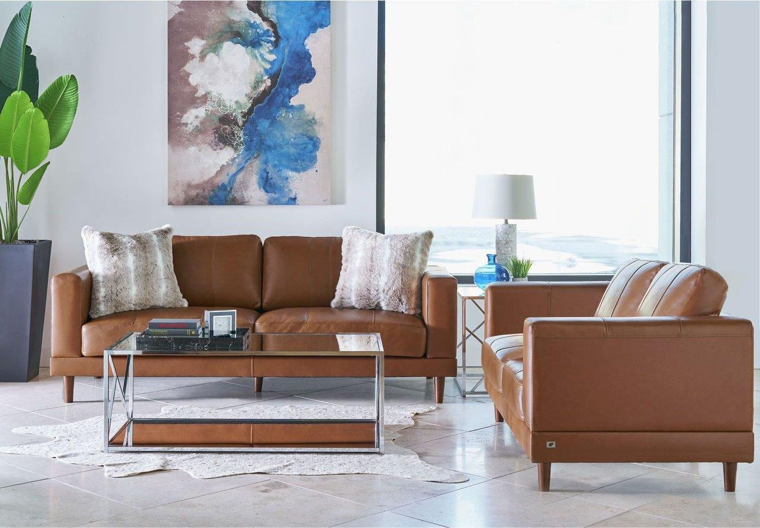 The appearance of Hanson Fiero Tan Leather Living Room Set designed by Picket House in the modern / contemporary interior design. This beige piece of furniture  was selected by 1StopBedrooms from Hanson Collection to add a touch of cosiness and style into your home. Sku: UHT3783300;UHT3783200. Material: Plywood.