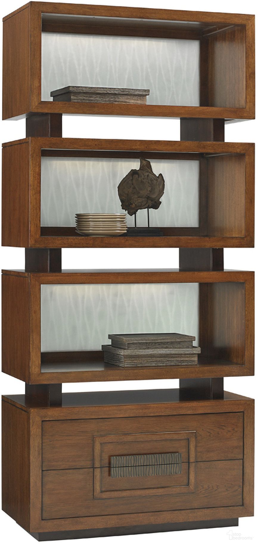 The appearance of Island Fusion Tonga Tiered Bookcase In Sebana designed by Tommy Bahama in the transitional interior design. This sebana piece of furniture was selected by 1StopBedrooms from Island Fusion Collection to add a touch of cosiness and style into your home. Sku: 556-990. Material: Wood.