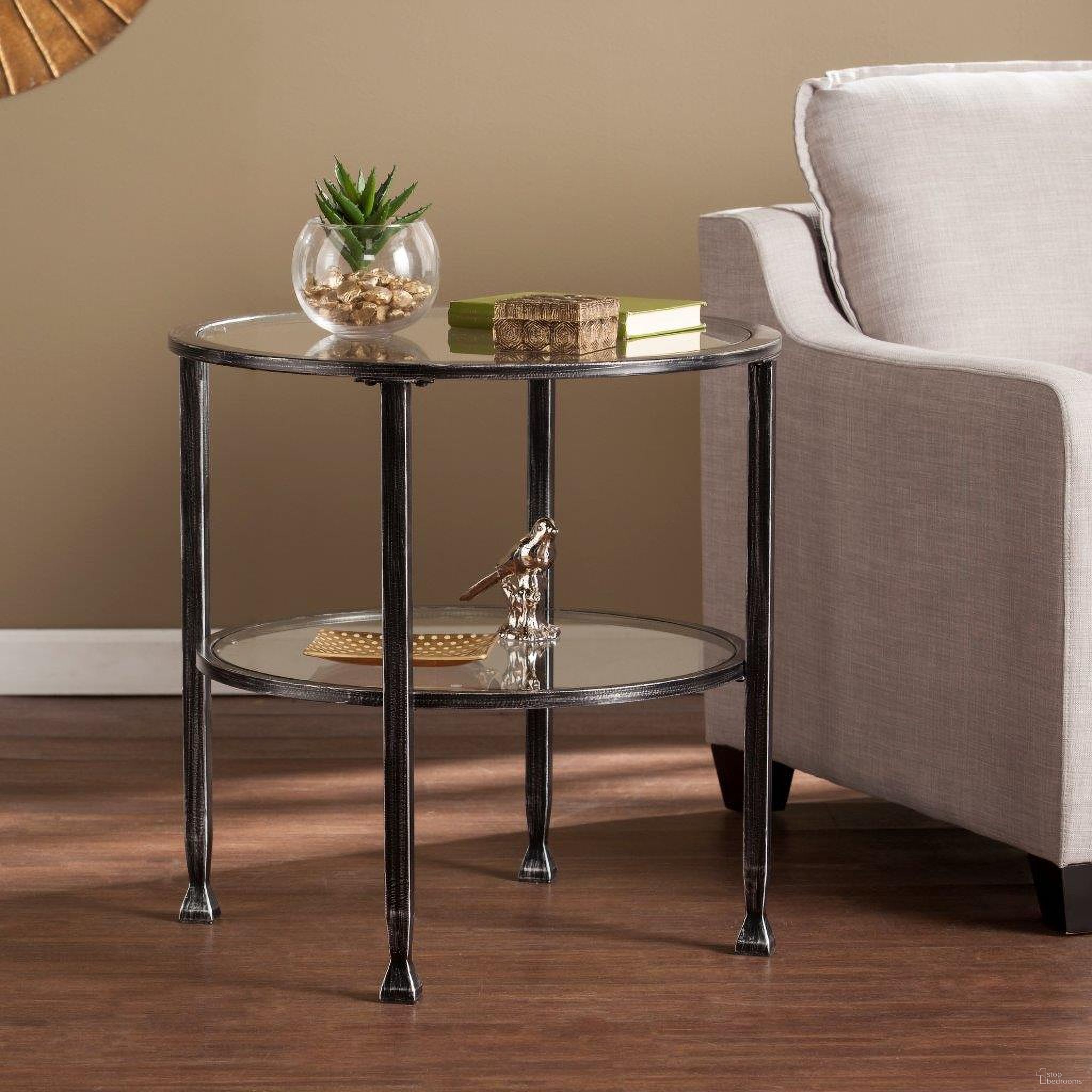 The appearance of Jaymes Metal And Glass Round End Table In Black designed by SEI Furniture in the modern / contemporary interior design. This black piece of furniture  was selected by 1StopBedrooms from Jaymes Collection to add a touch of cosiness and style into your home. Sku: CK8742. Material: Glass.