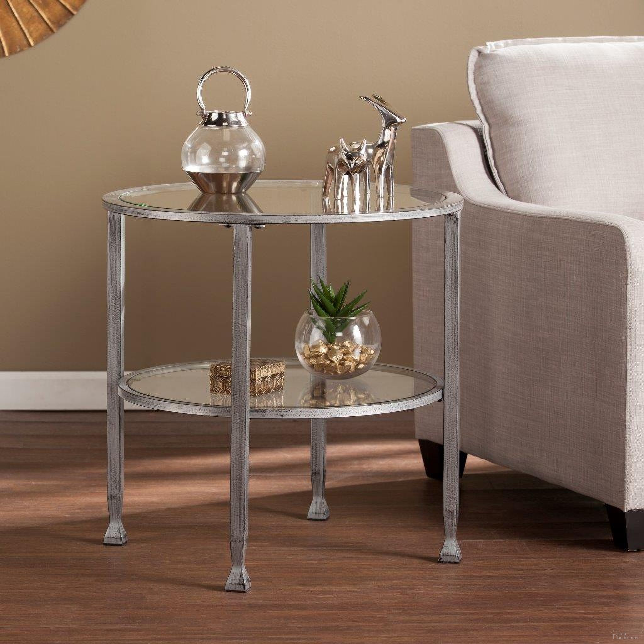 The appearance of Jaymes Metal And Glass Round End Table In Silver designed by SEI Furniture in the modern / contemporary interior design. This silver piece of furniture  was selected by 1StopBedrooms from Jaymes Collection to add a touch of cosiness and style into your home. Sku: CK0742. Material: Iron.