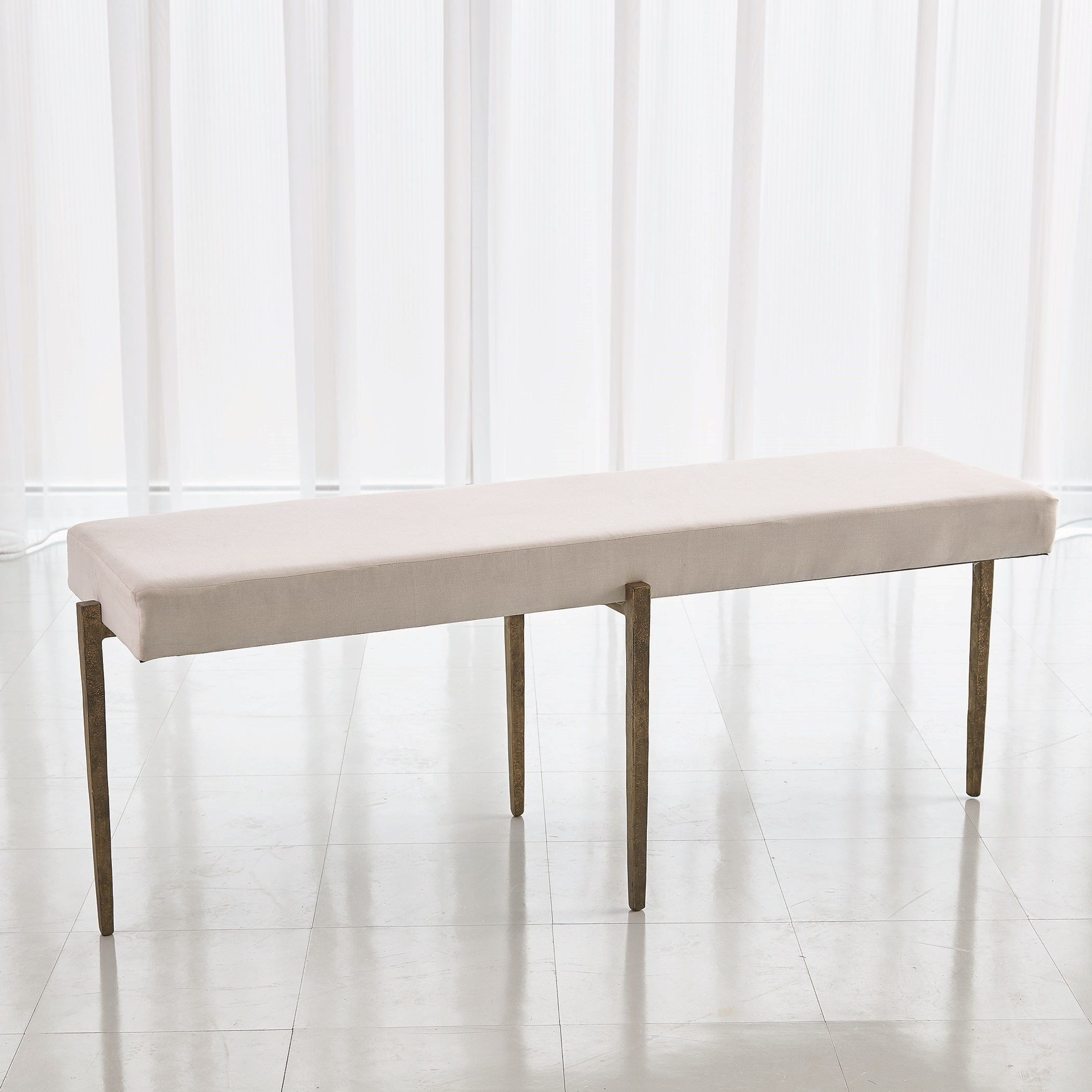 The appearance of Laforge Large Bench In Antique Gold With Muslin Cushion designed by Global Views in the modern / contemporary interior design. This gold piece of furniture  was selected by 1StopBedrooms from Laforge Collection to add a touch of cosiness and style into your home. Sku: 790864. Material: Iron.