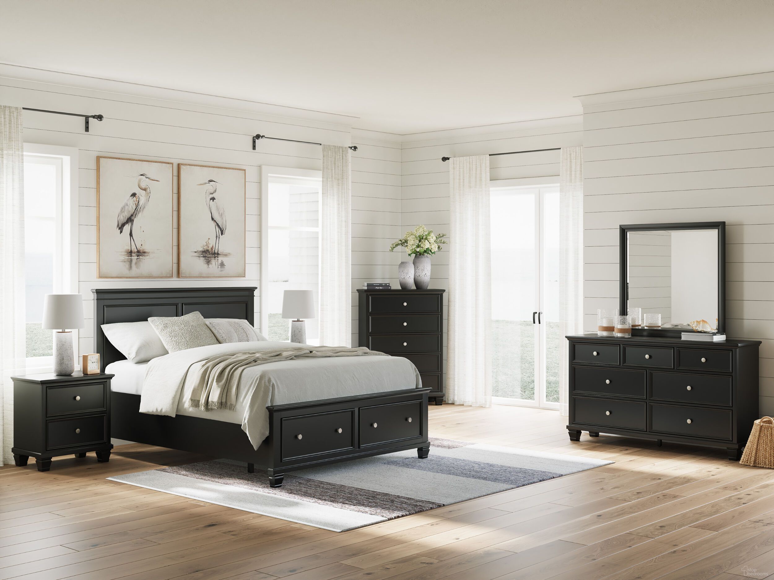 The appearance of Lanolee Panel Storage Bedroom Set In Black designed by Signature Design by Ashley in the transitional interior design. This black piece of furniture  was selected by 1StopBedrooms from Lanolee Collection to add a touch of cosiness and style into your home. Sku: B687-54S;B687-57;B687-99;B687-92. Material: Wood. Bed Size: California King.