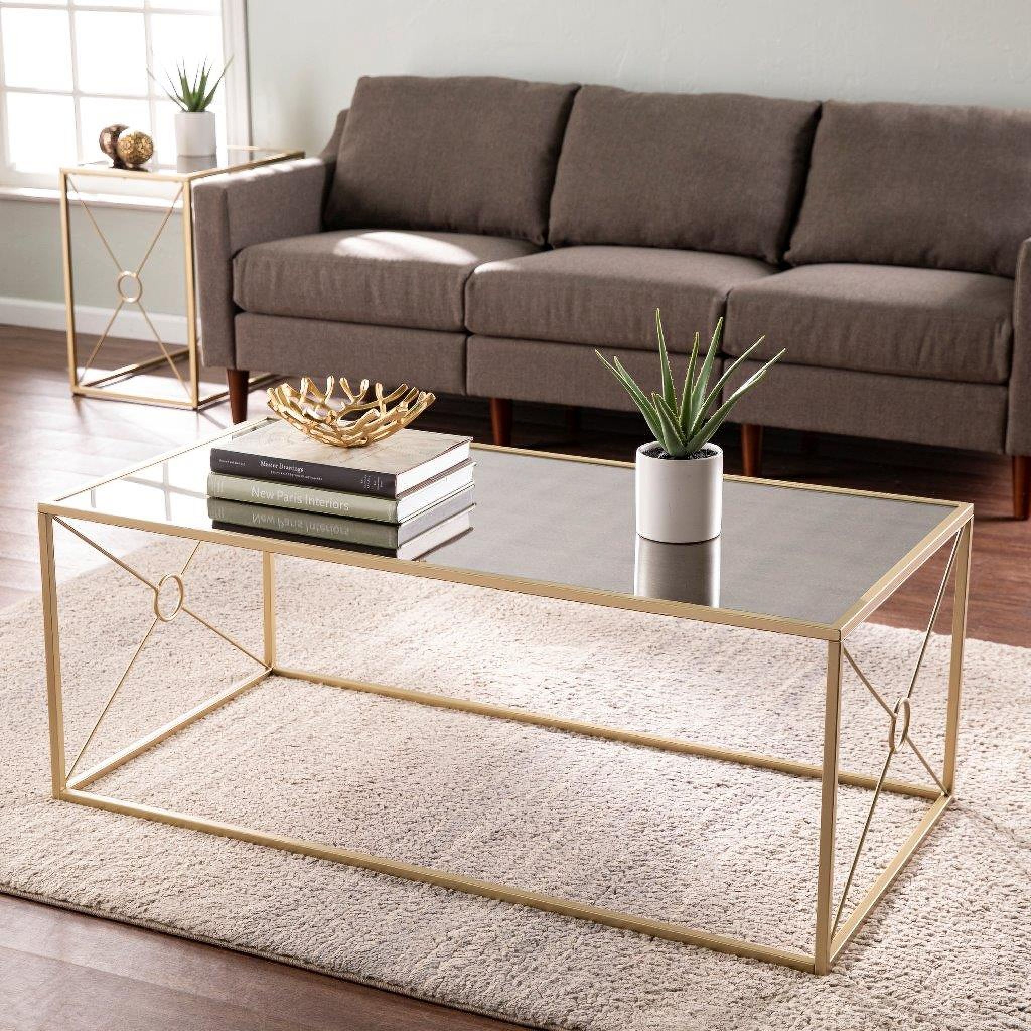 The appearance of Larden Mirror-Top Cocktail Table designed by SEI Furniture in the transitional interior design. This gold piece of furniture  was selected by 1StopBedrooms from Larden Collection to add a touch of cosiness and style into your home. Sku: CK1136800. Material: Iron.