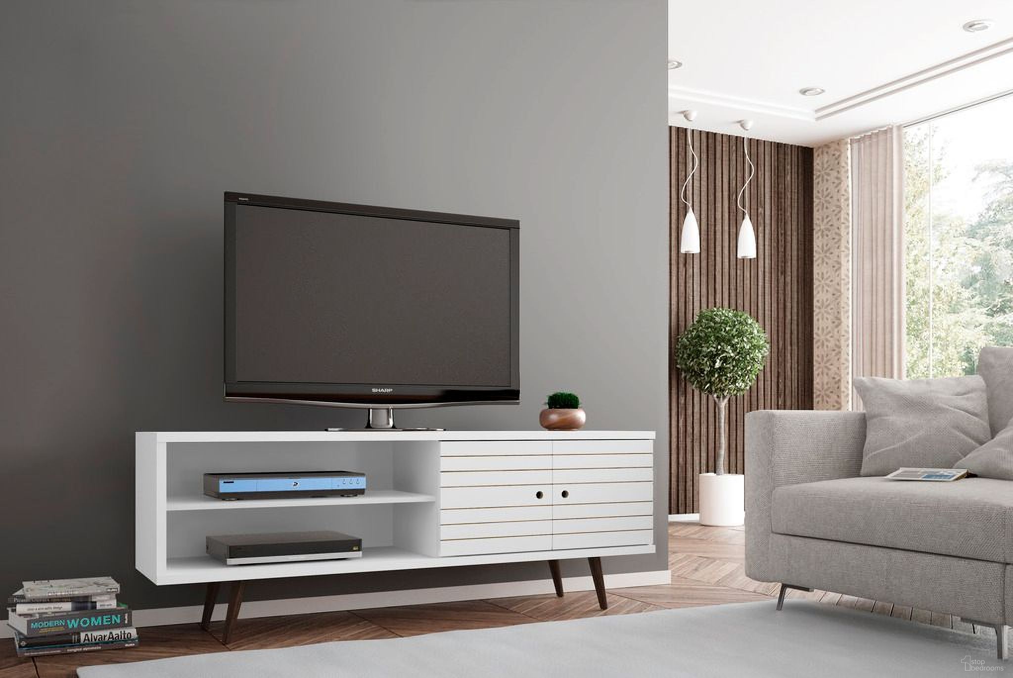 The appearance of Liberty 62.99 Inch Mid-Century - Modern TV Stand With 3 Shelves And 2 Doors In White With Solid Wood Legs designed by Manhattan Comfort in the transitional interior design. This white piece of furniture was selected by 1StopBedrooms from Liberty Collection to add a touch of cosiness and style into your home. Sku: 201AMC6. Material: MDF.