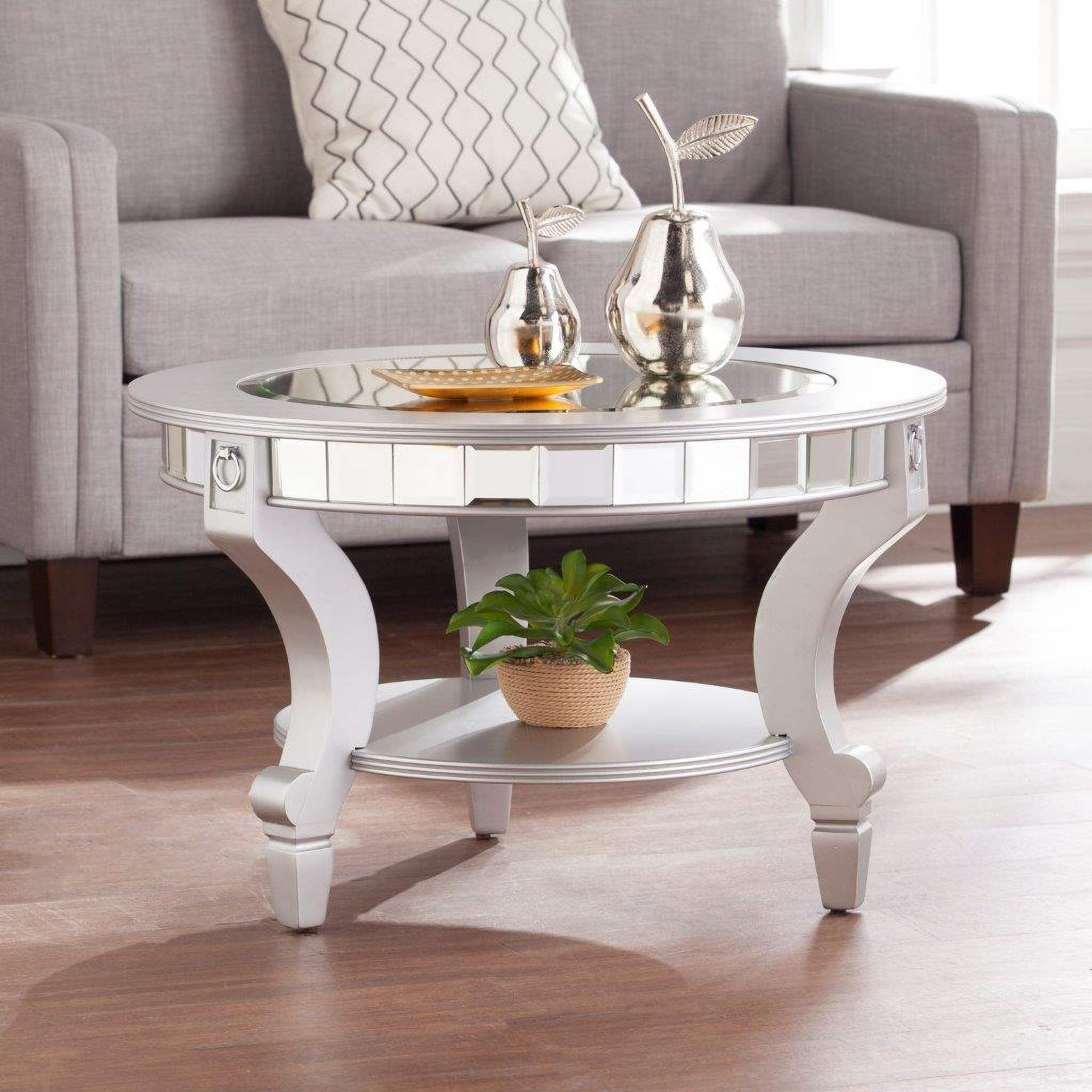 The appearance of Linsay Mirrored Round Cocktail Table designed by SEI Furniture in the glam interior design. This silver piece of furniture was selected by 1StopBedrooms from Linsay Collection to add a touch of cosiness and style into your home. Sku: CK2380. Material: MDF.