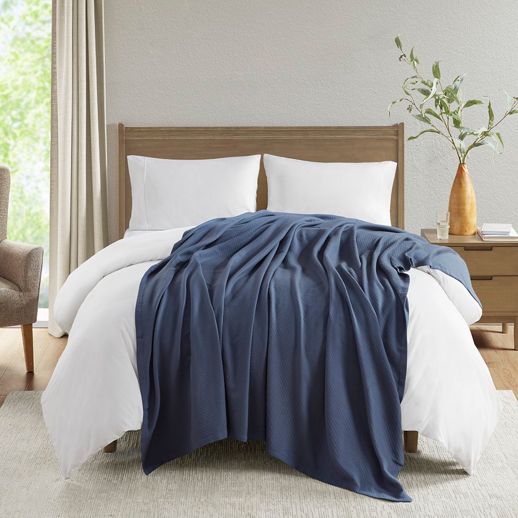 The appearance of Liquid Cotton Full/Queen Blanket In Navy designed by Olliix in the transitional interior design. This navy piece of furniture was selected by 1StopBedrooms from Liquid Cotton Collection to add a touch of cosiness and style into your home. Sku: MP51N-8380. Bed Size: Full. Material: Cotton.