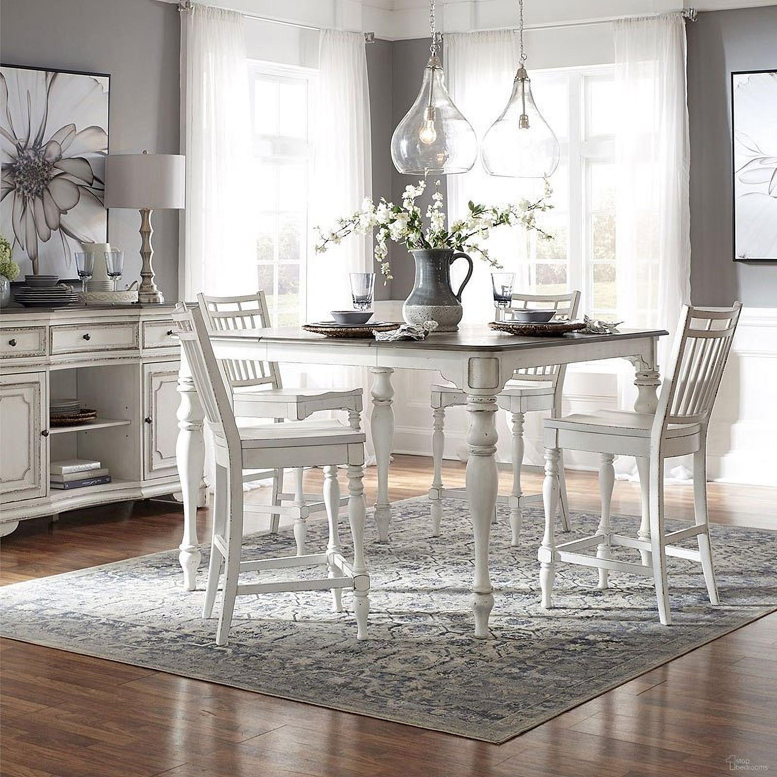 The appearance of Magnolia Manor Gathering Dining Room Set w/ Spindle Back Chairs designed by Liberty in the traditional interior design. This antique white piece of furniture was selected by 1StopBedrooms from Magnolia Manor Collection to add a touch of cosiness and style into your home. Sku: 244-GT5454;244-B400024. Table Base Style: Legs. Table Top Shape: Square. Material: Rubberwood. Size: 54" x 54".