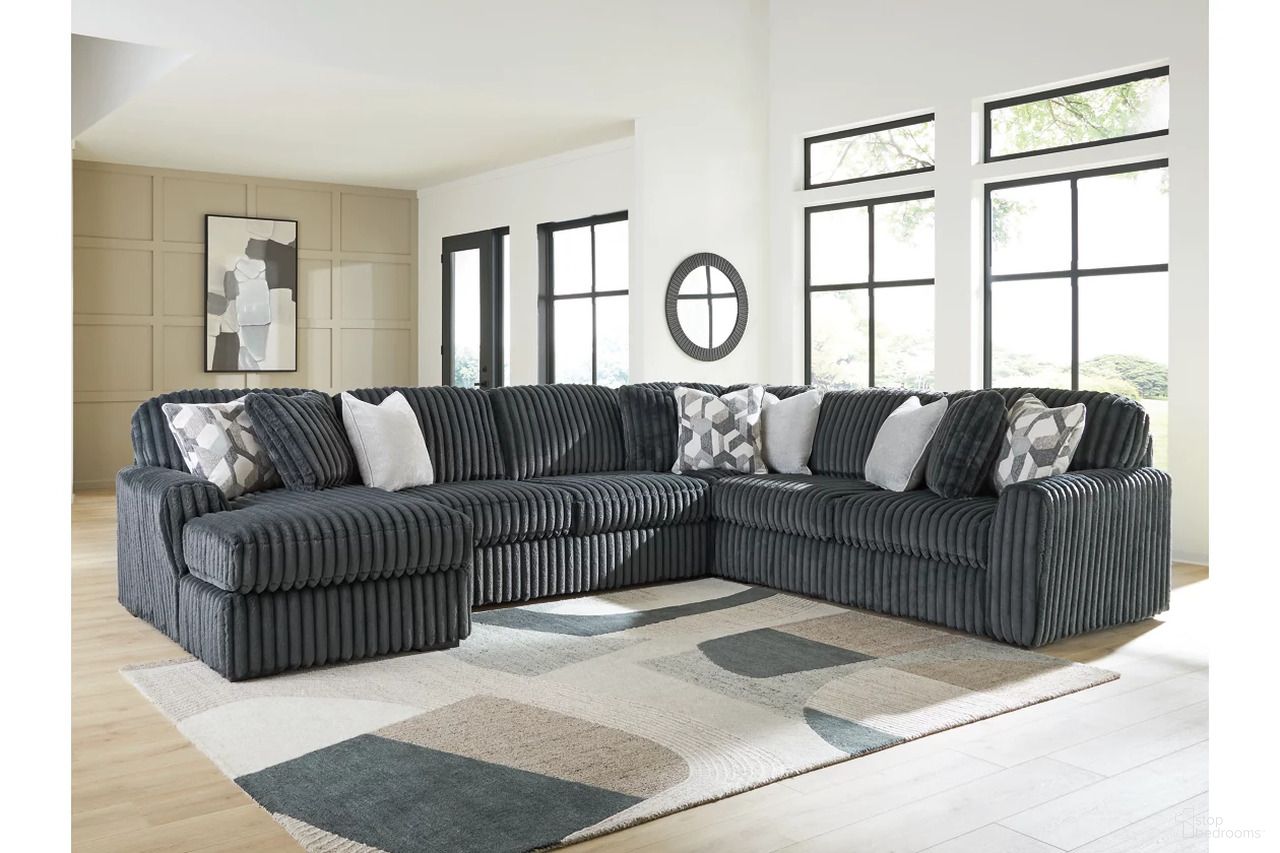 The appearance of Midnight-Madness 4-Piece Sectional with LAF Chaise In Gunmetal designed by Signature Design by Ashley in the modern / contemporary interior design. This gunmetal piece of furniture  was selected by 1StopBedrooms from Midnight-Madness Collection to add a touch of cosiness and style into your home. Sku: 9810516;9810534;9810577;9810567. Material: Polyester. Layout: Sofa & Chaise.