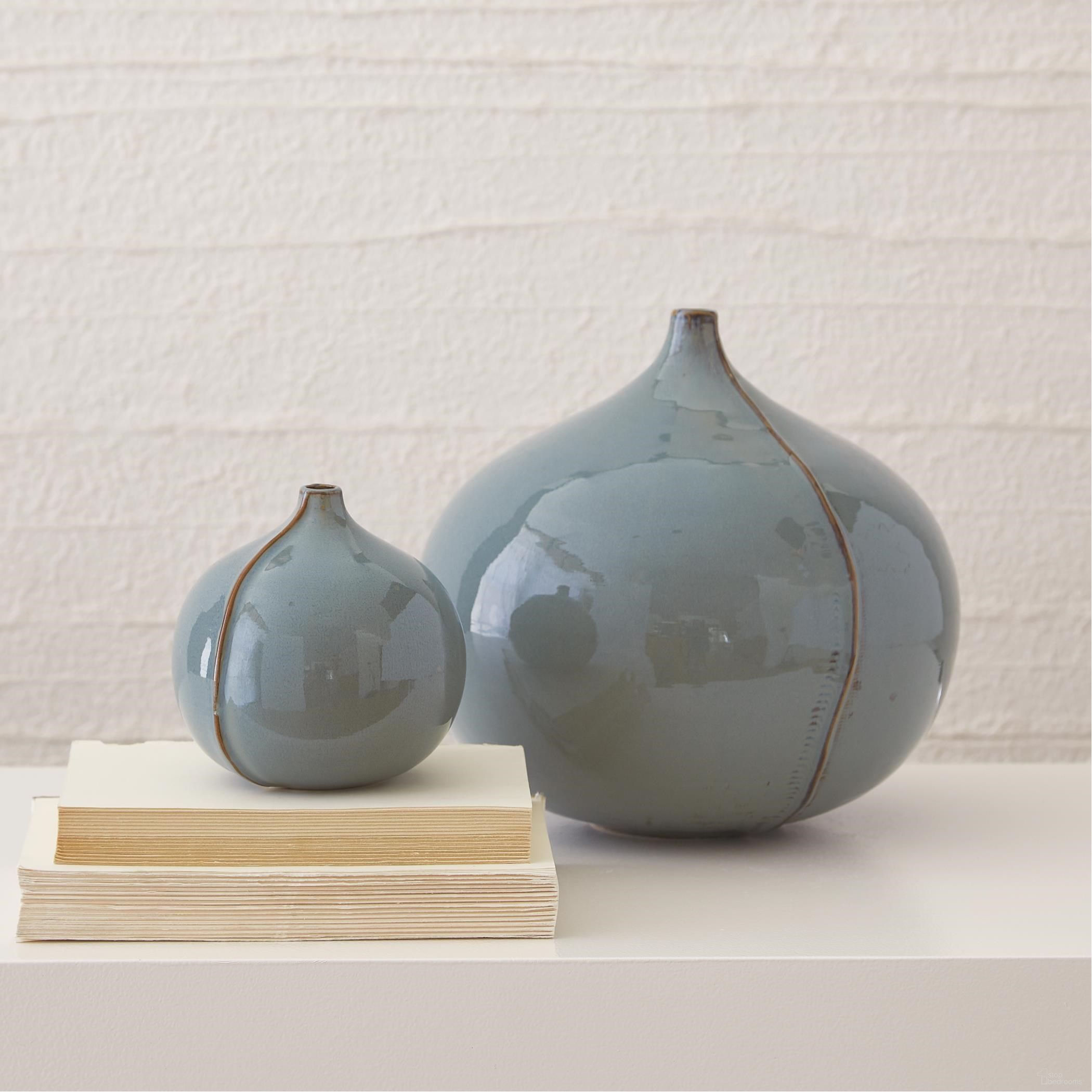 The appearance of Milo Small Vase In Blue designed by Global Views in the modern / contemporary interior design. This blue piece of furniture was selected by 1StopBedrooms from Milo Collection to add a touch of cosiness and style into your home. Sku: 780509. Material: Ceramic.
