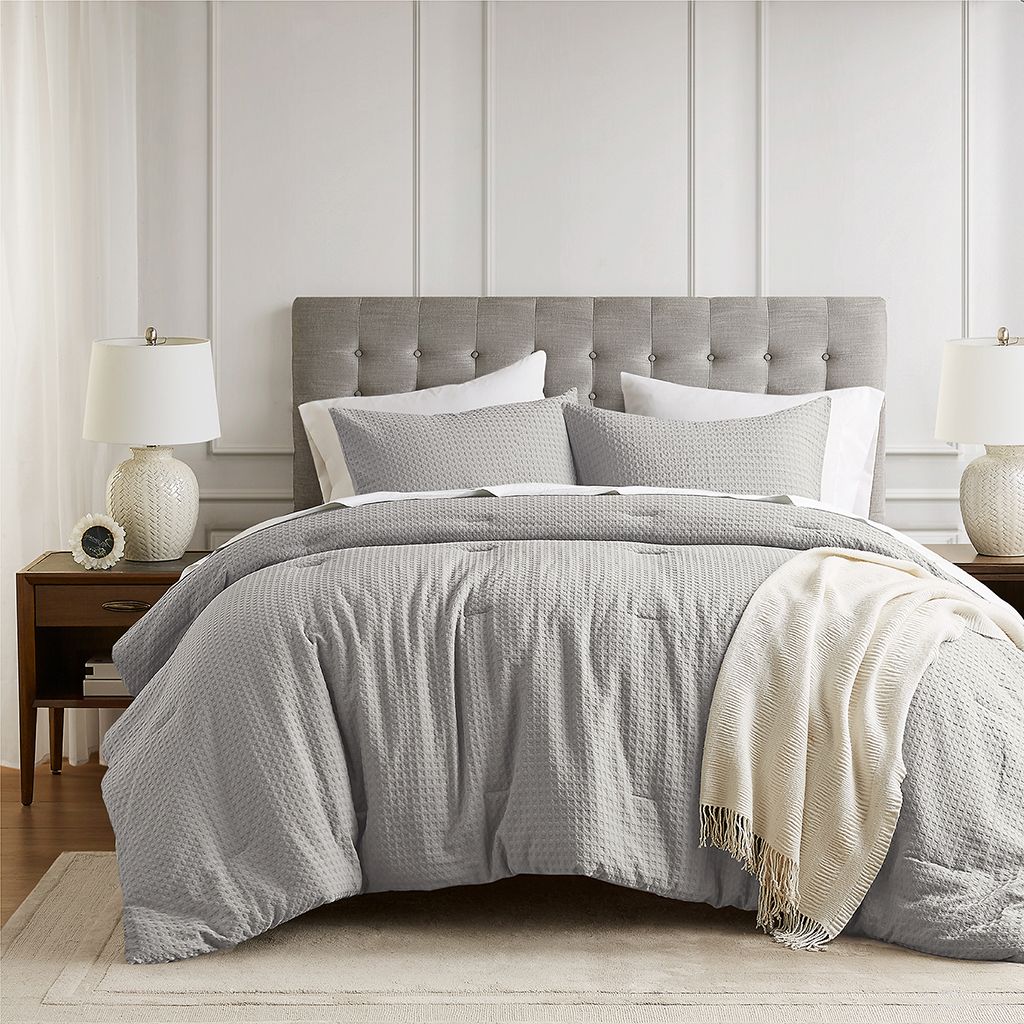 The appearance of Mina Waffle Weave Textured Comforter Set In Light Grey designed by Olliix in the modern / contemporary interior design. This light grey piece of furniture  was selected by 1StopBedrooms from Mina Collection to add a touch of cosiness and style into your home. Sku: AM10-0012. Material: Polyester. Bed Size: King.