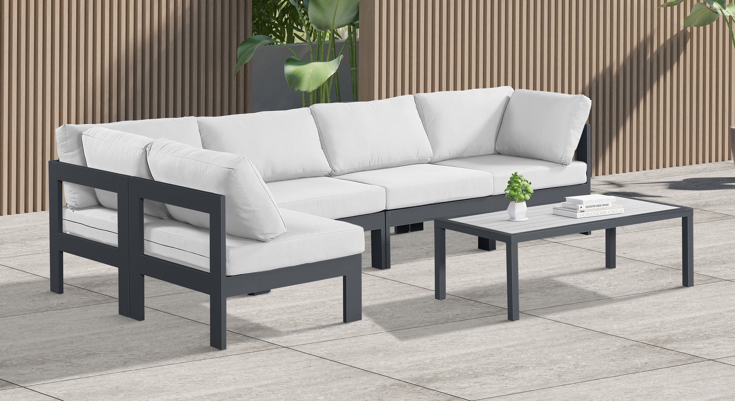The appearance of Nizuc Water Resistant Fabric Outdoor Patio 5 Piece Modular Sectional In White designed by Meridian in the modern / contemporary interior design. This white piece of furniture was selected by 1StopBedrooms from Nizuc Collection to add a touch of cosiness and style into your home. Sku: 376White-Corner;376White-Corner;376White-Armless;376White-Armless;376White-Armless. Material: Aluminum.