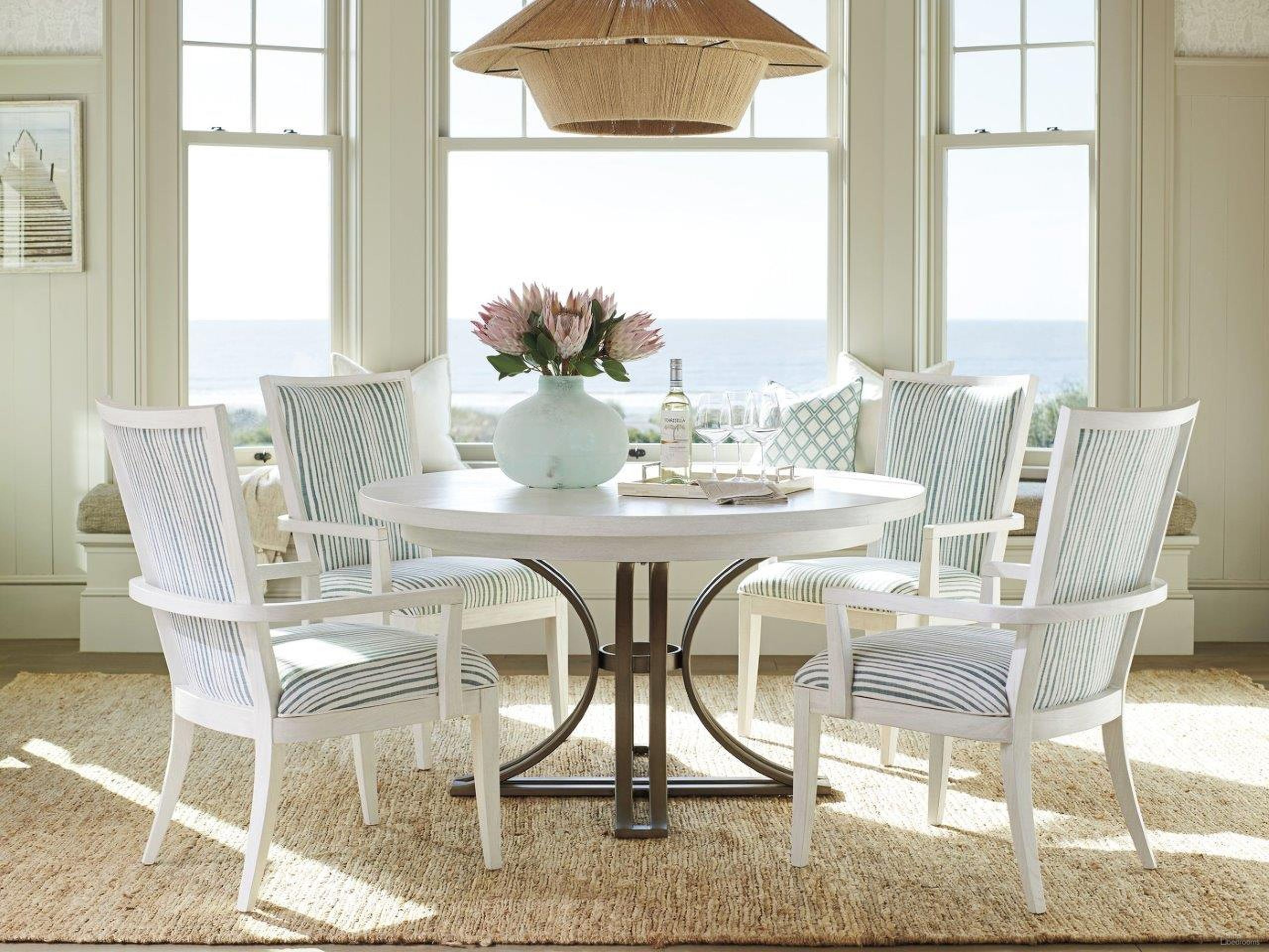 The appearance of Ocean Breeze Sand Savannah Round Extendable Dining Room Set designed by Tommy Bahama in the transitional interior design. This sand piece of furniture  was selected by 1StopBedrooms from Ocean Breeze Collection to add a touch of cosiness and style into your home. Sku: 570-875C;570-880-01. Table Base Style: Pedestal. Table Top Shape: Round. Material: Wood. Size: 54".