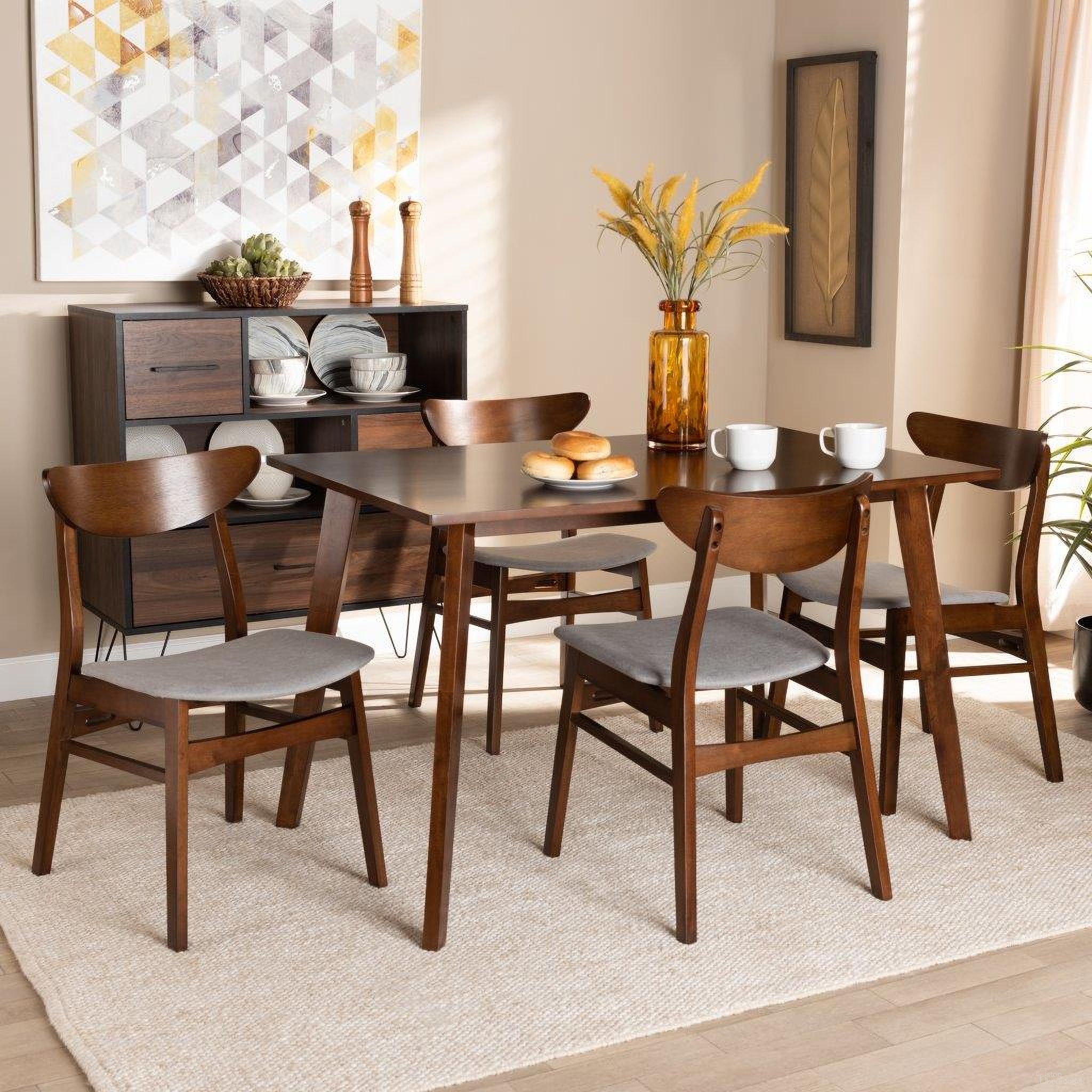 The appearance of Orion Mid-Century Modern Transitional Light Grey Fabric Upholstered and Walnut Brown Finished Wood 5-Piece Dining Set designed by Baxton Studio in the transitional interior design. This walnut brown piece of furniture was selected by 1StopBedrooms from Orion Collection to add a touch of cosiness and style into your home. Sku: Parlin/Fiesta-Smoke/Walnut-5PC Dining Set. Material: Polyester.