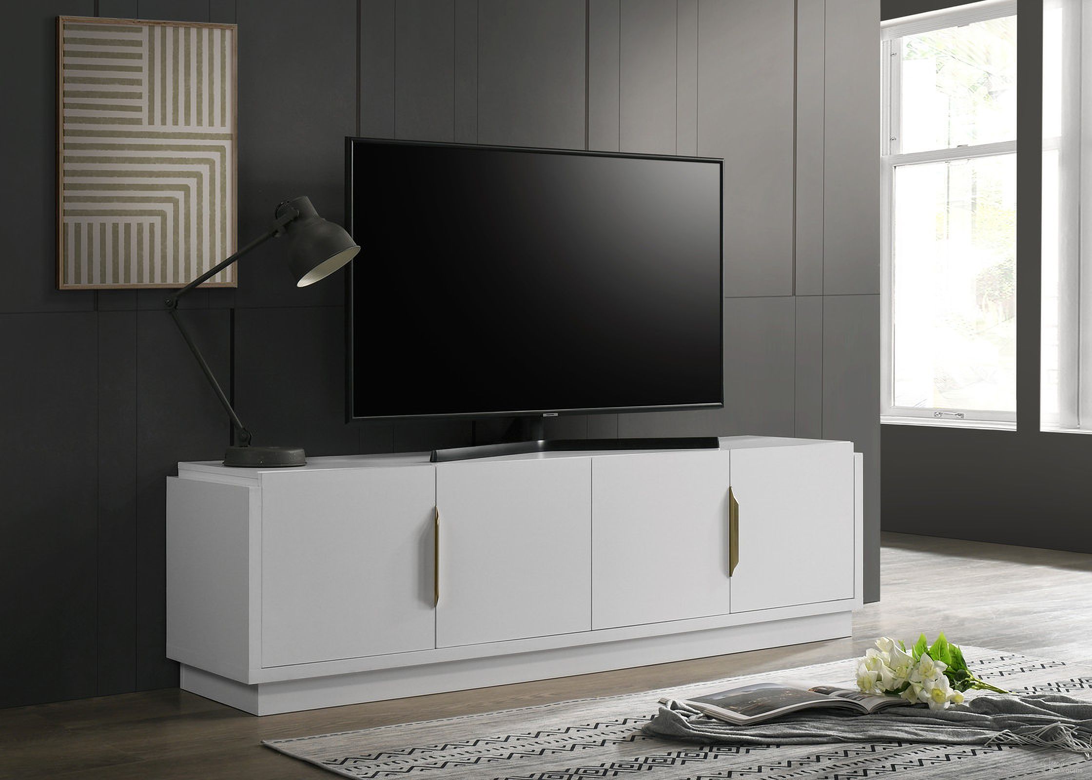 The appearance of Palmer 70 Inch 4-Door TV Stand In White designed by Lilola Home in the modern / contemporary interior design. This white piece of furniture was selected by 1StopBedrooms from Palmer Collection to add a touch of cosiness and style into your home. Sku: 97034. Material: Wood.