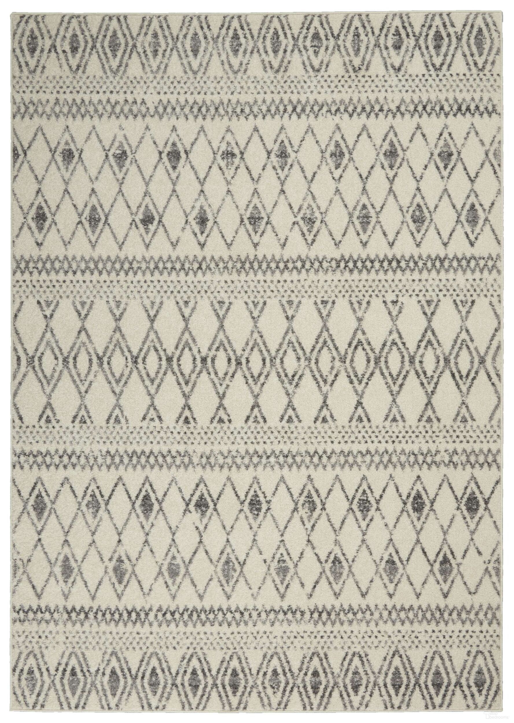 The appearance of Passion Ivory and Grey 5'3" x 7'3" Bohemian Area Rug designed by Nourison in the bohemian interior design. This ivory and grey piece of furniture was selected by 1StopBedrooms from Passion Collection to add a touch of cosiness and style into your home. Sku: 99446793447. Material: Polypropylene.