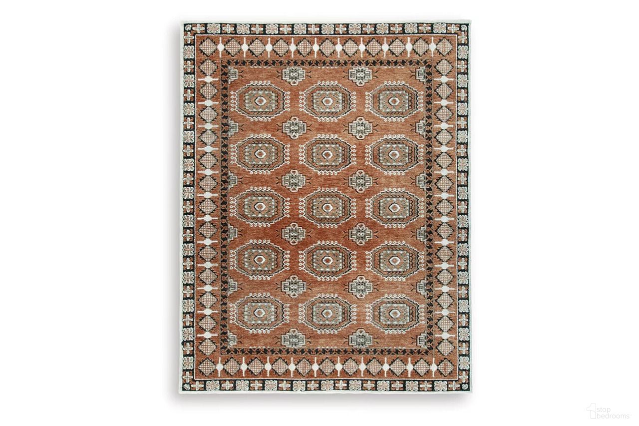 The appearance of Qaabiz 7'8" x 10' Area Rug In Sienna/Ivory/Black designed by Signature Design by Ashley in the traditional interior design. This sienna/ivory/black piece of furniture was selected by 1StopBedrooms from Qaabiz Collection to add a touch of cosiness and style into your home. Sku: R407521. Material: Polyester.
