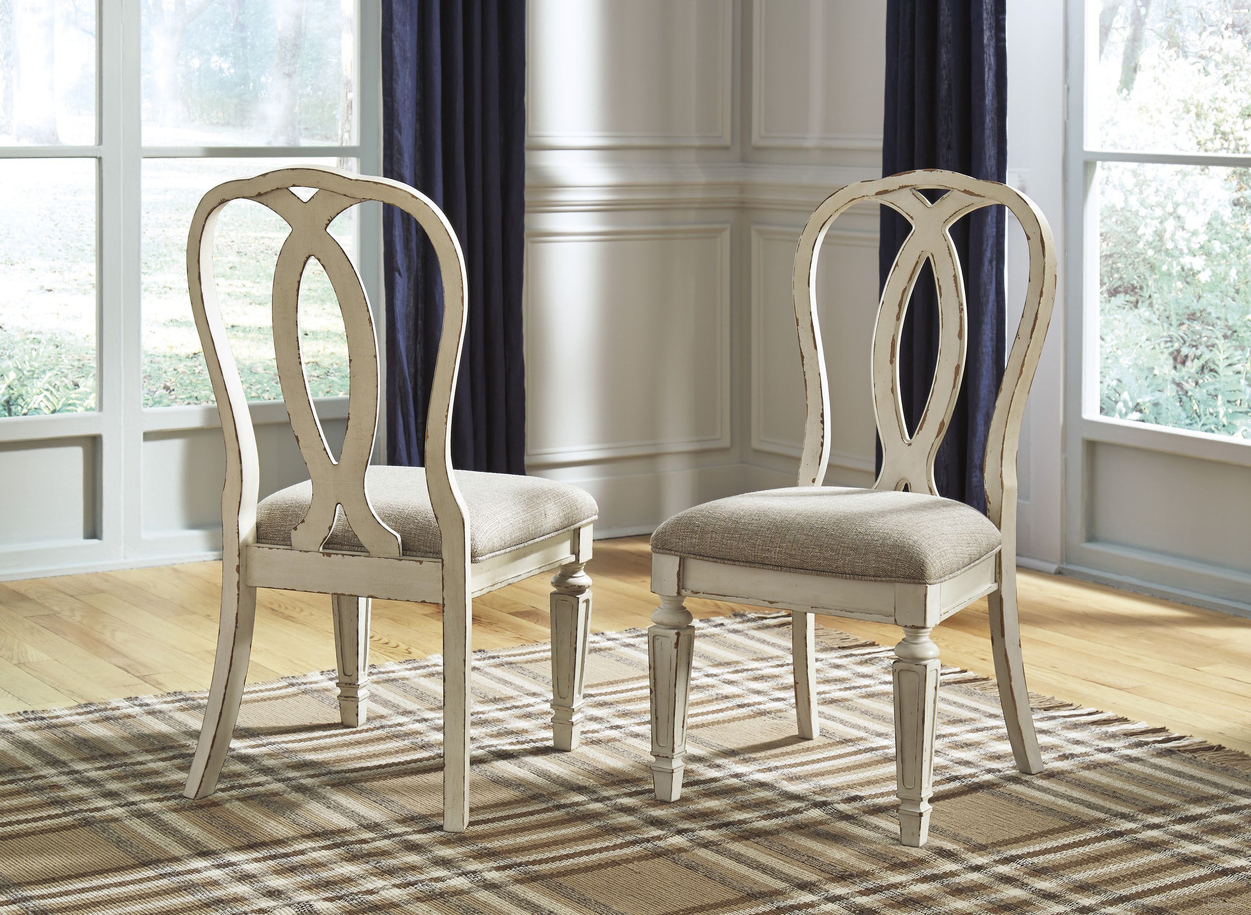The appearance of Realyn White Dining Upholstered Sidechair Set of 2 designed by Signature Design by Ashley in the transitional interior design. This chipped white piece of furniture was selected by 1StopBedrooms from Realyn Collection to add a touch of cosiness and style into your home. Sku: D743-02. Material: Fabric. Chair Type: Side Chair.