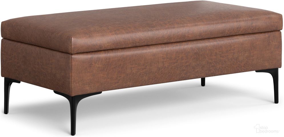 The appearance of Rebecca Faux Leather Large Coffee Table Storage Ottoman with Lift up Lid In Distressed Saddle Brown designed by Simpli Home in the transitional interior design. This distressed saddle brown piece of furniture  was selected by 1StopBedrooms from Rebecca Collection to add a touch of cosiness and style into your home. Sku: AXCOTREBLGLU-DSB. Material: Faux Leather.