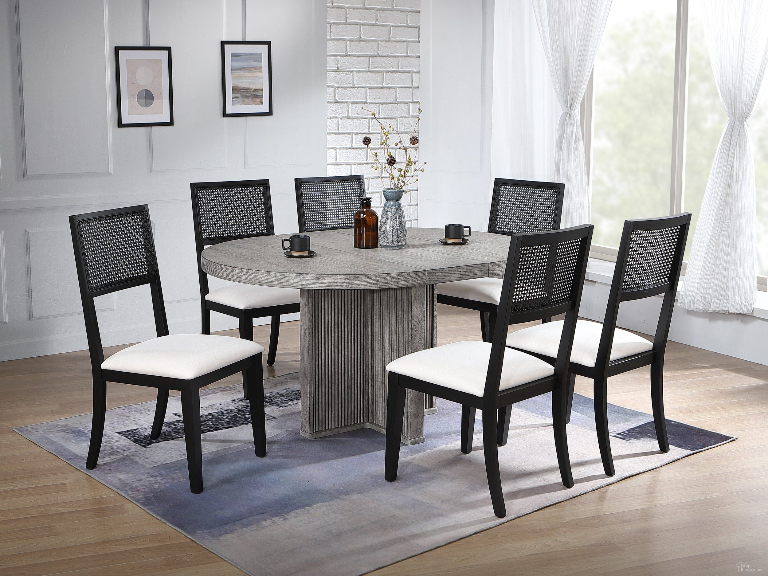 The appearance of Ripple Dining Table and Robin 7-Piece Dining Set In Dove Grey and Black Finish designed by Iconic Furniture in the modern / contemporary interior design. This dove grey/black piece of furniture was selected by 1StopBedrooms from Urbana Collection to add a touch of cosiness and style into your home. Sku: RD45RPLDG-CH67U01BLKDG-7PC. Table Base Style: Pedestal. Table Top Shape: Round. Material: Rubberwood.
