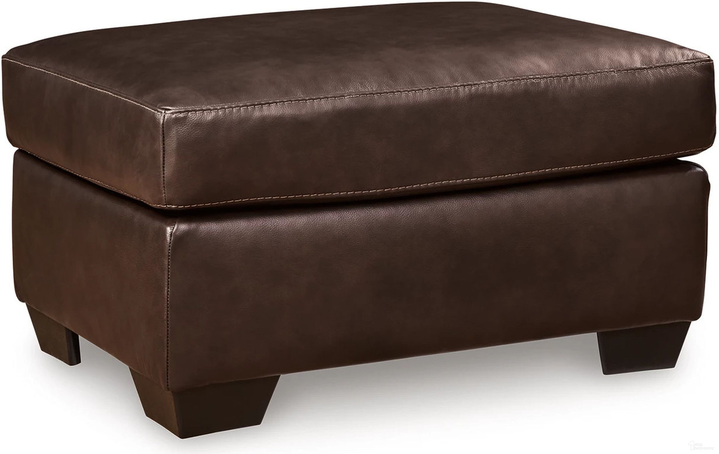 The appearance of Santorine Ottoman In Dark Brown designed by Signature Design by Ashley in the modern / contemporary interior design. This dark brown piece of furniture  was selected by 1StopBedrooms from Santorine Collection to add a touch of cosiness and style into your home. Sku: 2170614. Material: Faux Leather.