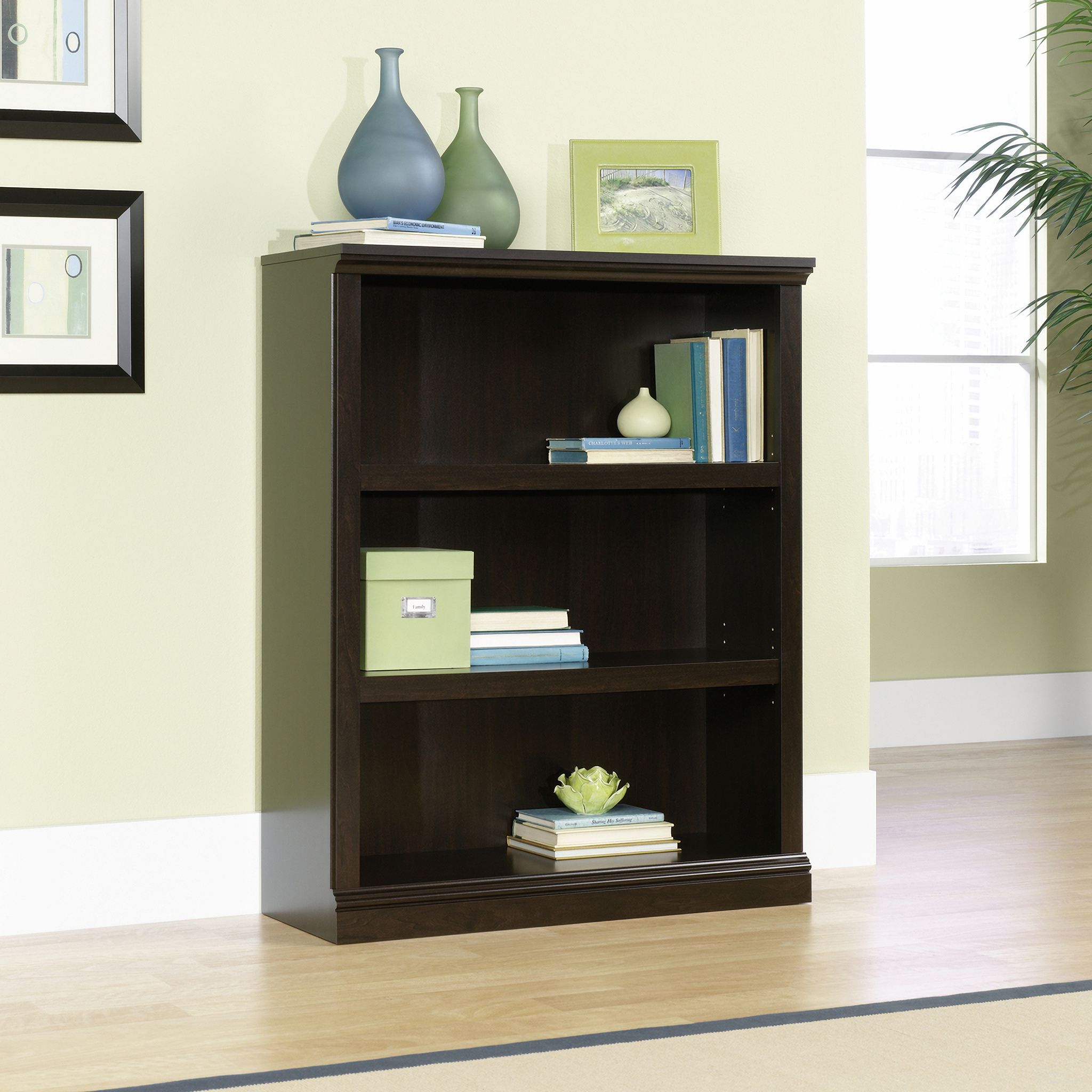 The appearance of Sauder Select 3-Shelf Bookcase In Jamocha Wood designed by Sauder in the transitional interior design. This jamocha wood piece of furniture was selected by 1StopBedrooms from Sauder Select Collection to add a touch of cosiness and style into your home. Sku: 410373. Material: Engineered Wood.
