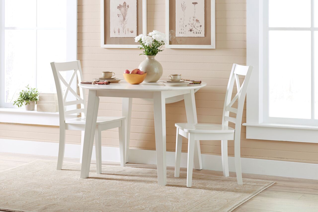 The appearance of Simplicity Paperwhite Round Extendable Dining Room Set designed by Jofran in the transitional interior design. This white piece of furniture  was selected by 1StopBedrooms from Simplicity Collection to add a touch of cosiness and style into your home. Sku: 652-28;652-806KD. Table Base Style: Legs. Table Top Shape: Round. Material: Rubberwood. Size: 42".