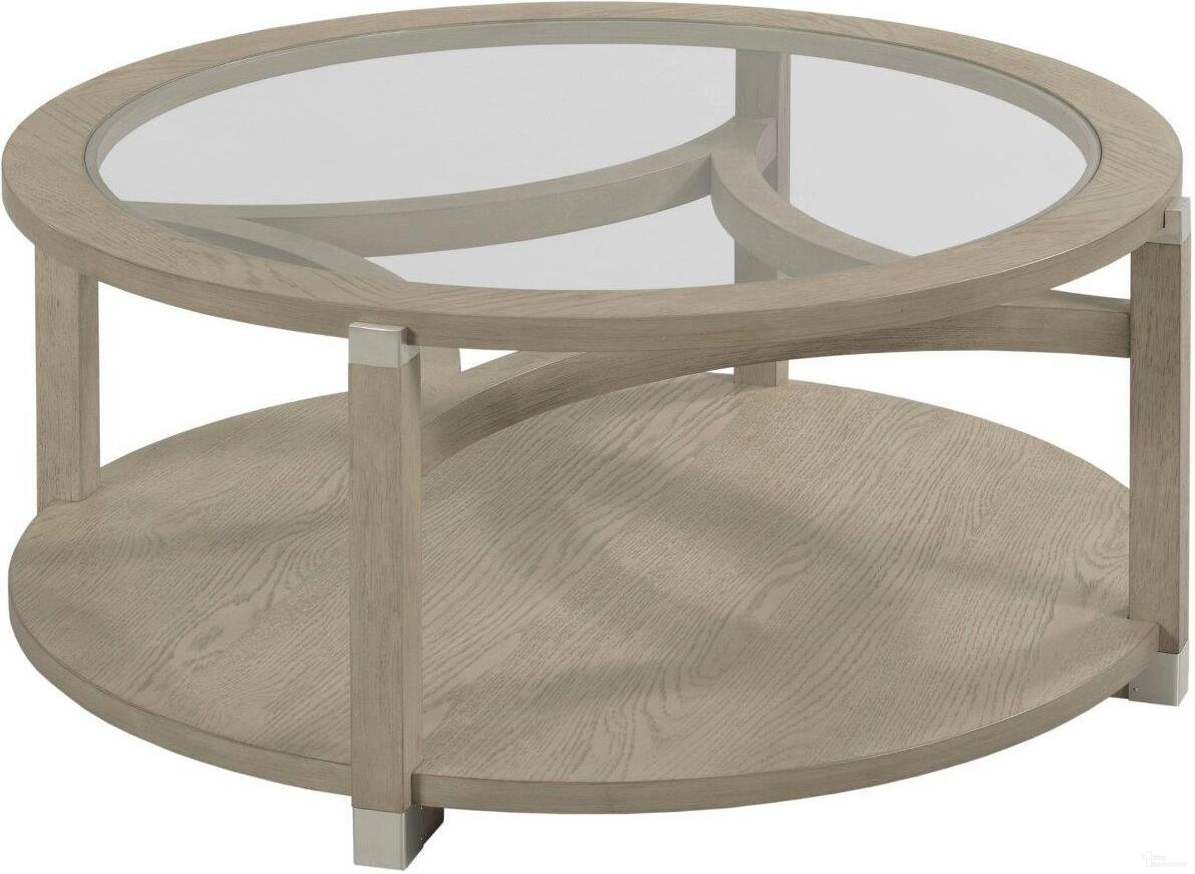 The appearance of Solstice Round Coffee Table designed by Hammary in the modern / contemporary interior design. This light stain piece of furniture  was selected by 1StopBedrooms from Solstice Collection to add a touch of cosiness and style into your home. Sku: 086-911. Material: Wood.