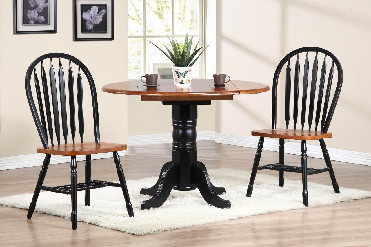 The appearance of Sunset Trading Black Cherry Selections 3 Piece 42 Inch Round Drop Leaf Dining Set with Arrowback Chairs designed by Sunset Trading in the modern / contemporary interior design. This antique black and cherry piece of furniture  was selected by 1StopBedrooms from Black Cherry Selections Collection to add a touch of cosiness and style into your home. Sku: DLU-TPD-4242-BCH-T;DLU-TPD-4242-BCH-B;DLU-820-BCH-2. Material: Wood.