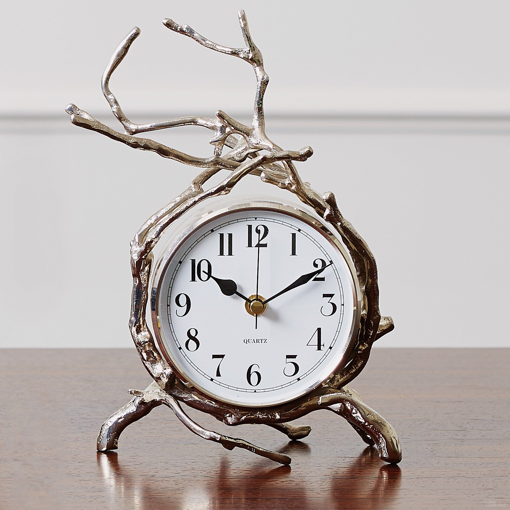 The appearance of Twig Clock In Nickel designed by Global Views in the modern / contemporary interior design. This nickel piece of furniture  was selected by 1StopBedrooms from Twig Collection to add a touch of cosiness and style into your home. Sku: 992884. Material: Brass.