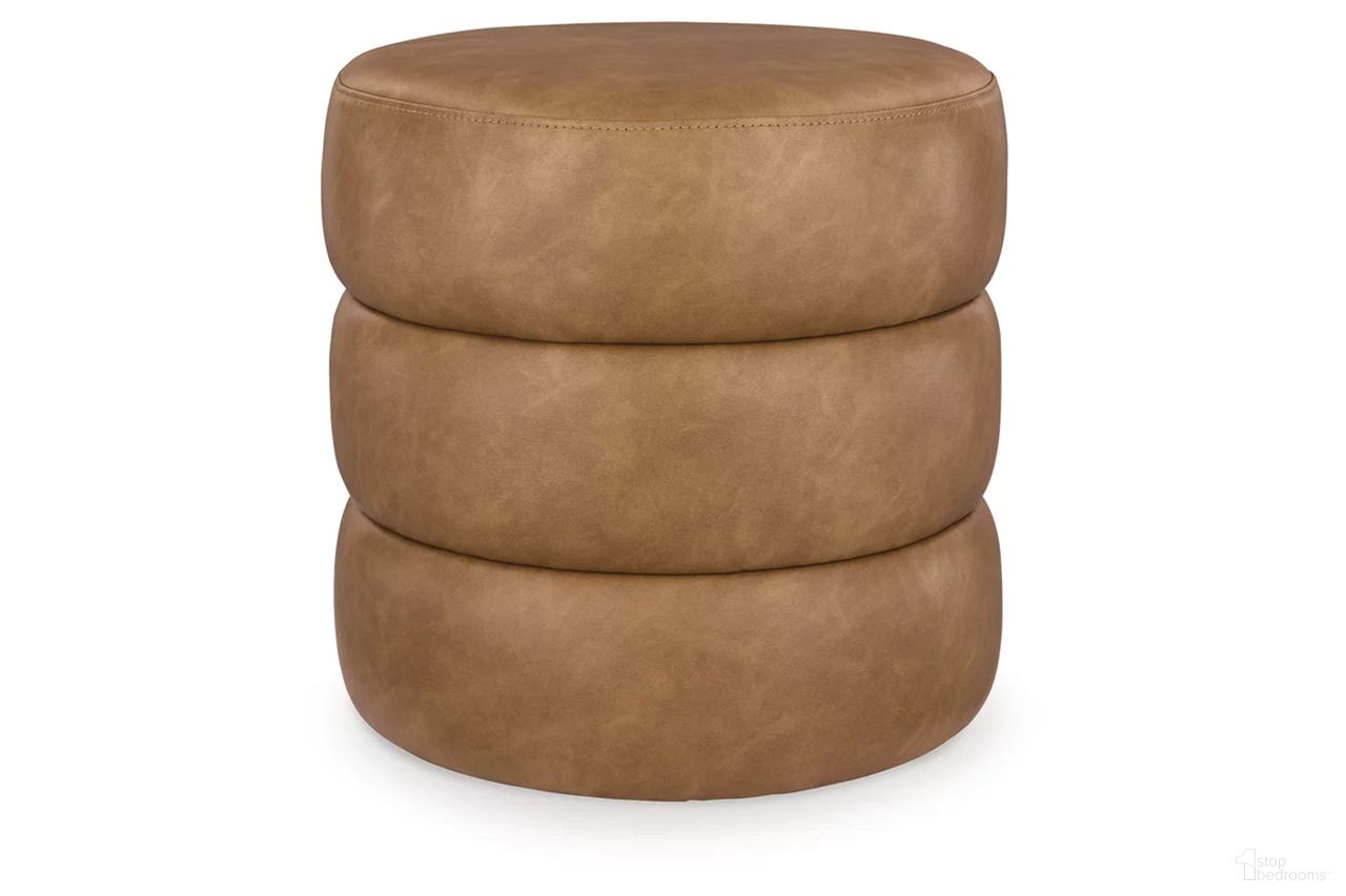 The appearance of Ummi Swivel Accent Ottoman In Caramel designed by Signature Design by Ashley in the transitional interior design. This caramel piece of furniture was selected by 1StopBedrooms from Ummi Collection to add a touch of cosiness and style into your home. Sku: A3000791. Material: Faux Leather.