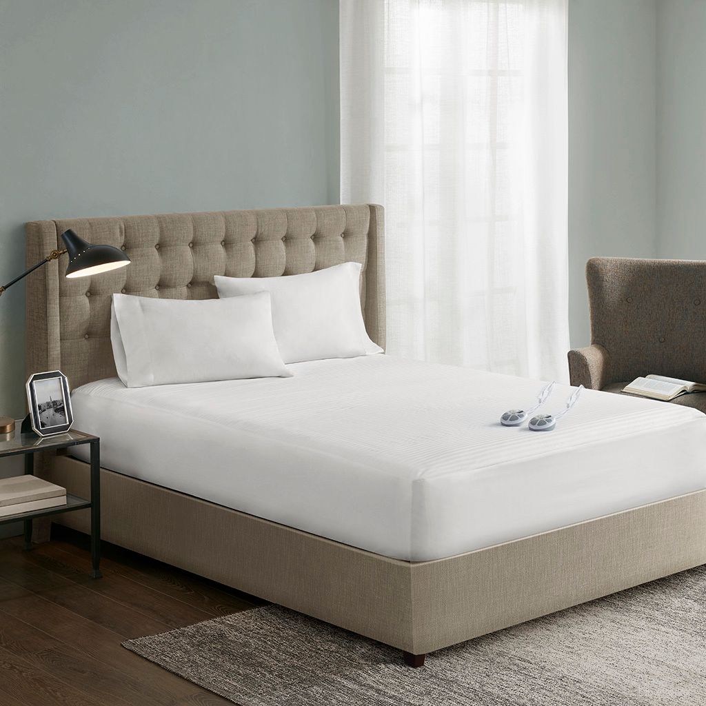 The appearance of Waterproof Heated King Mattress Pad In White designed by Olliix in the transitional interior design. This white piece of furniture was selected by 1StopBedrooms from Waterproof Collection to add a touch of cosiness and style into your home. Sku: ST55-0118. Material: Polyester. Bed Size: King. Mattress Size: King.