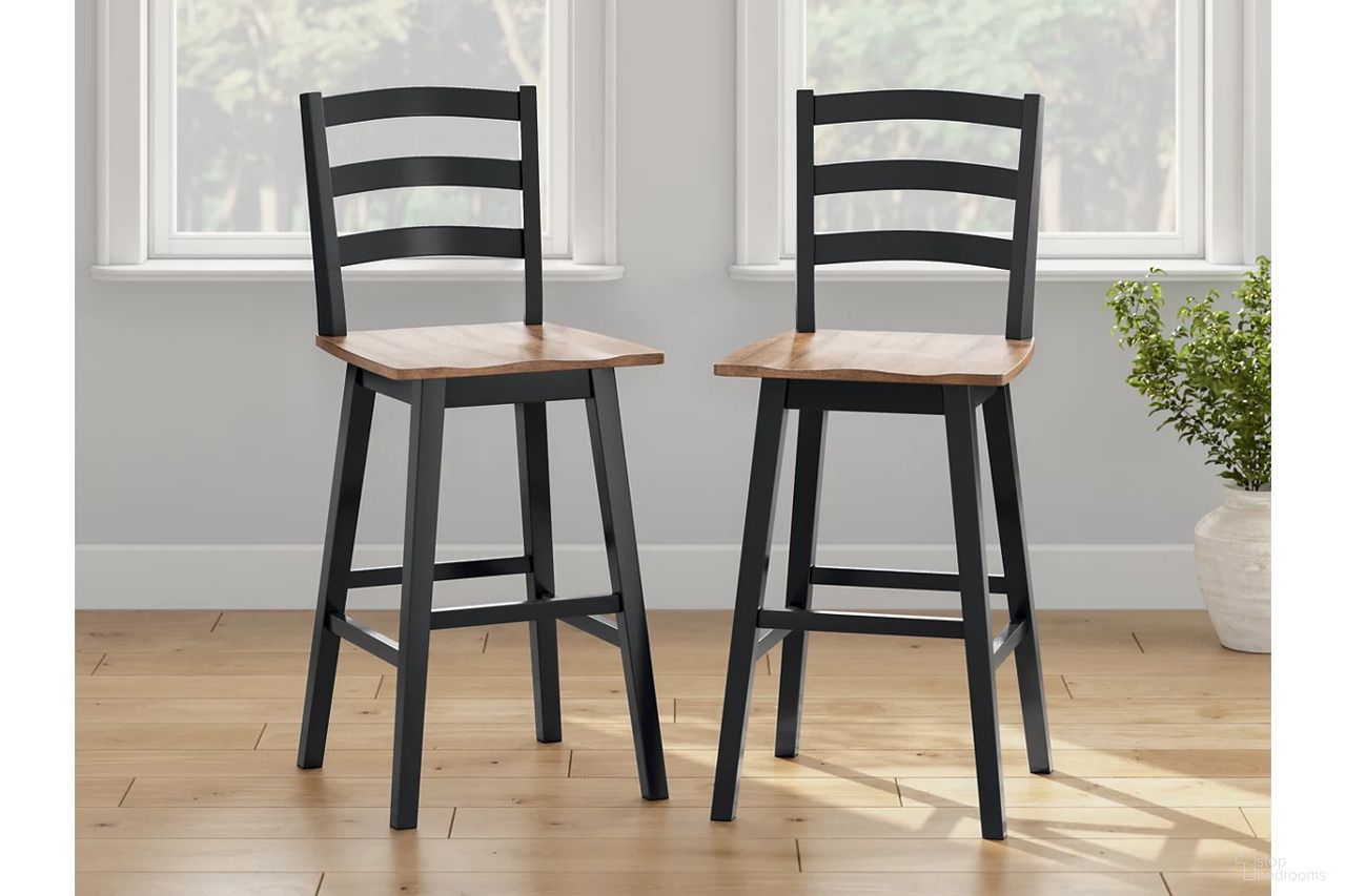 The appearance of Wildenauer Bar Height Bar Stool Set of 2 In Brown and Black designed by Signature Design by Ashley in the transitional interior design. This brown/black piece of furniture was selected by 1StopBedrooms from Wildenauer Collection to add a touch of cosiness and style into your home. Sku: D634-230. Material: Wood.