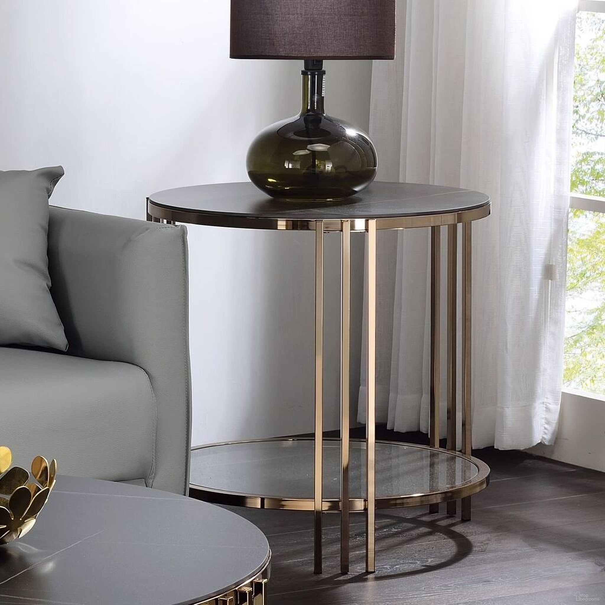 The appearance of Abisha End Table In Champagne designed by ACME in the modern / contemporary interior design. This champagne piece of furniture  was selected by 1StopBedrooms from Abisha Collection to add a touch of cosiness and style into your home. Sku: LV02816. Material: Metal.