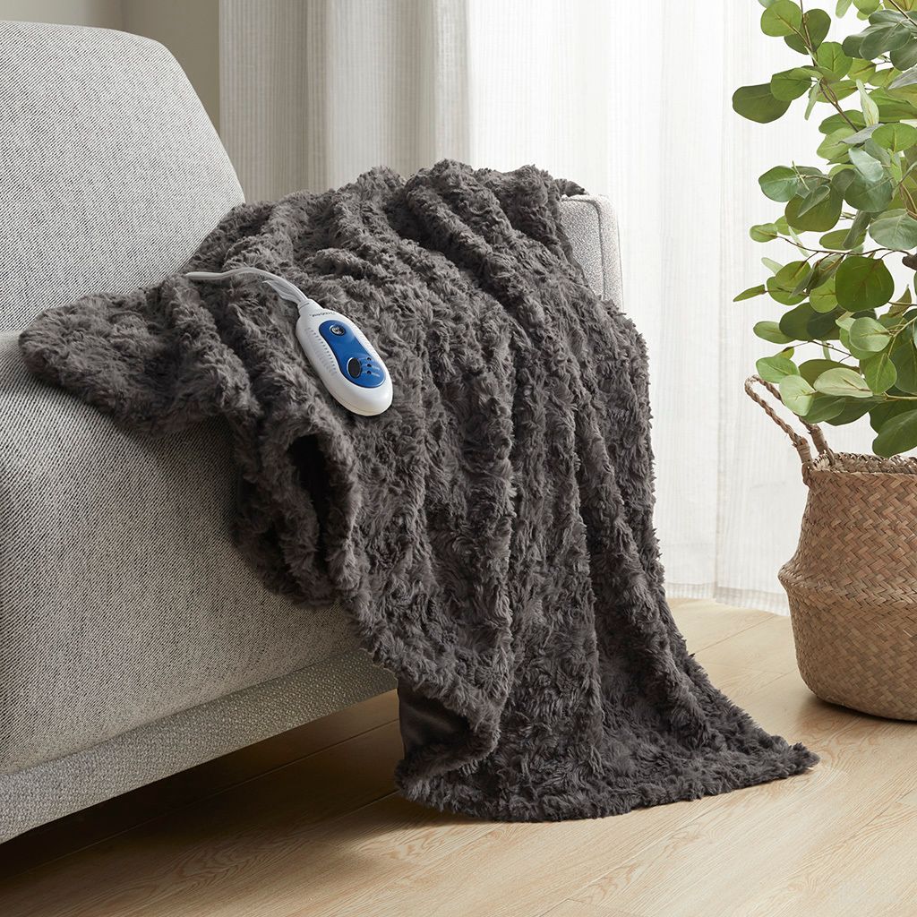 The appearance of Zuri Oversized Faux Fur Heated Throw In Dark Grey designed by Olliix in the glam interior design. This dark grey piece of furniture  was selected by 1StopBedrooms from Zuri Collection to add a touch of cosiness and style into your home. Sku: BR54-4181. Material: Polyester.